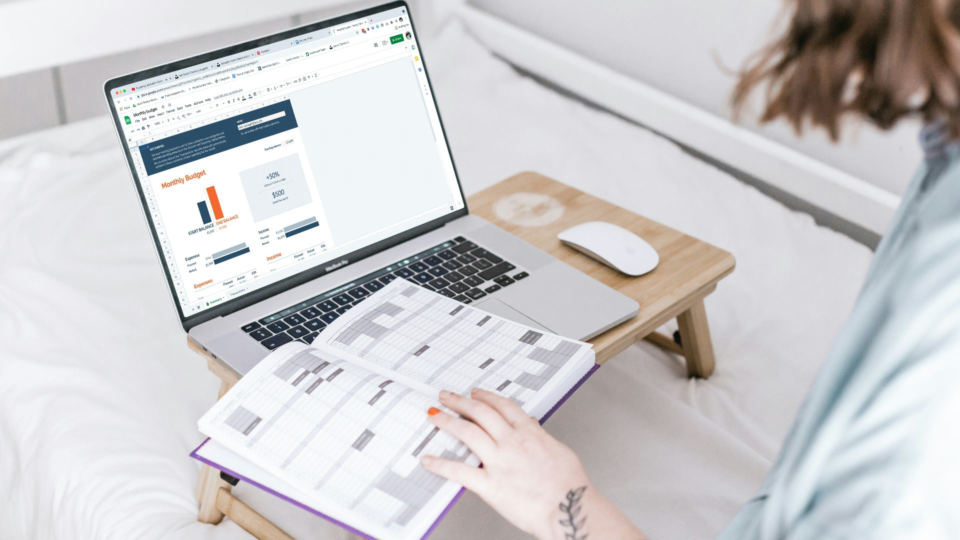 a person sitting on a bed with a laptop