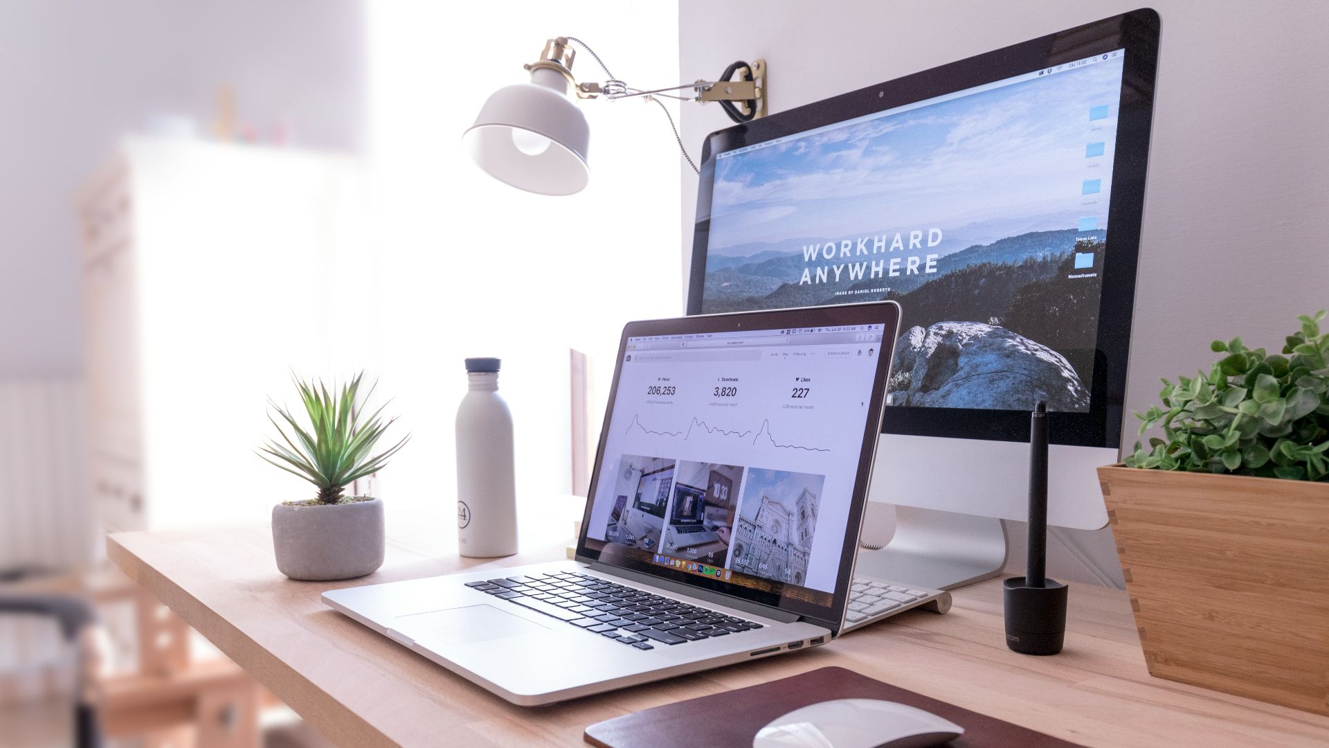 MacBook Pro on table beside white iMac and Magic Mouse