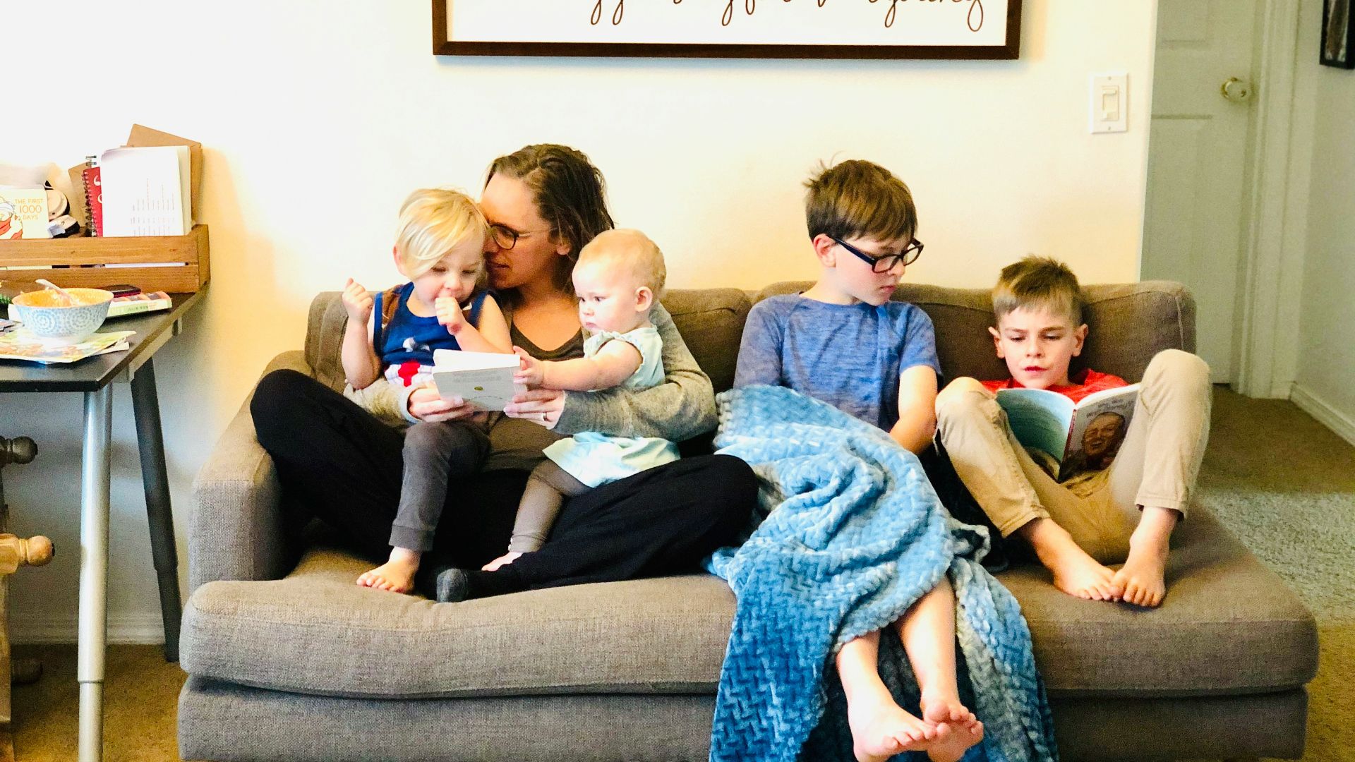 3 children sitting on gray couch