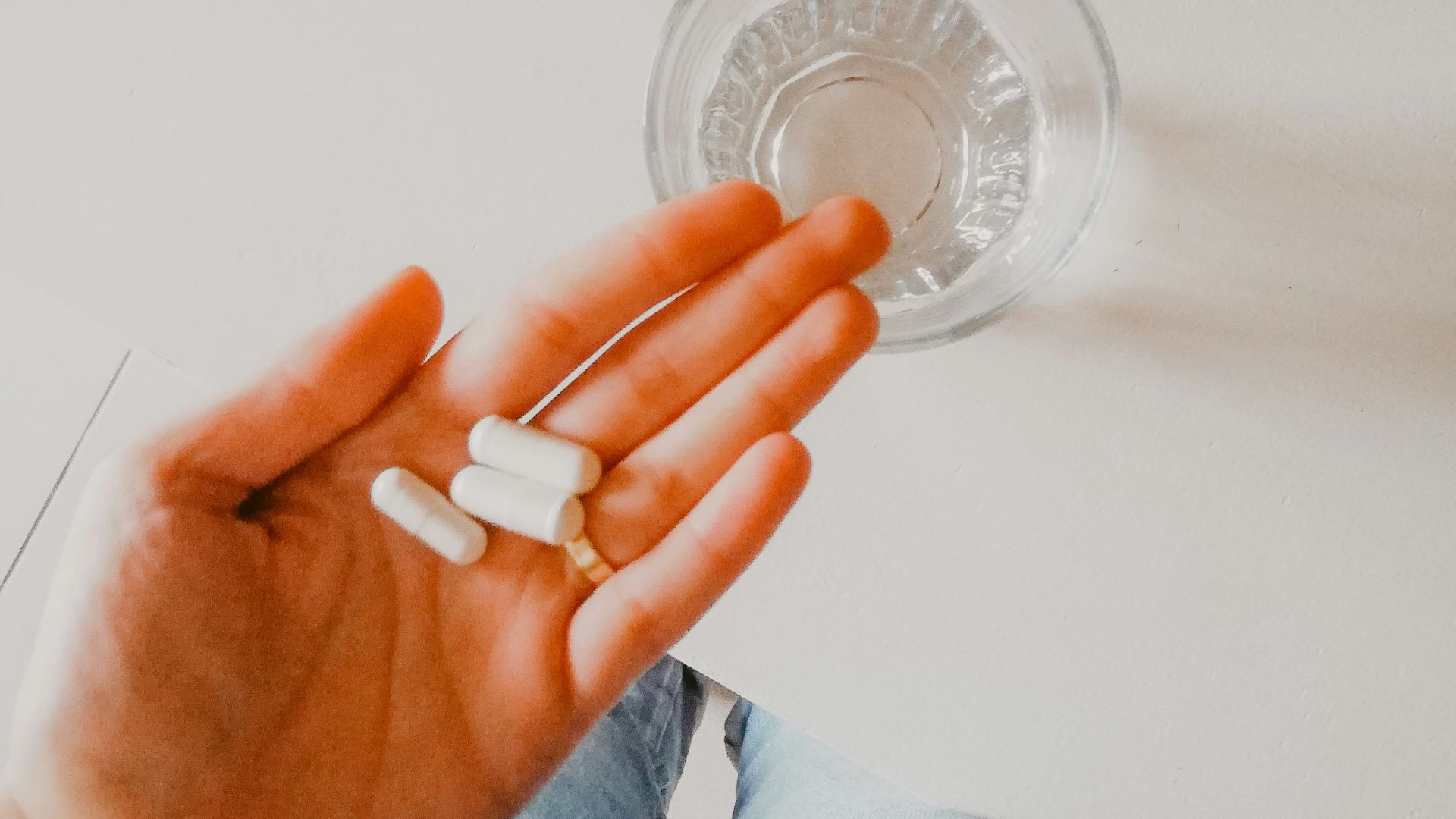 person holding white medication pill