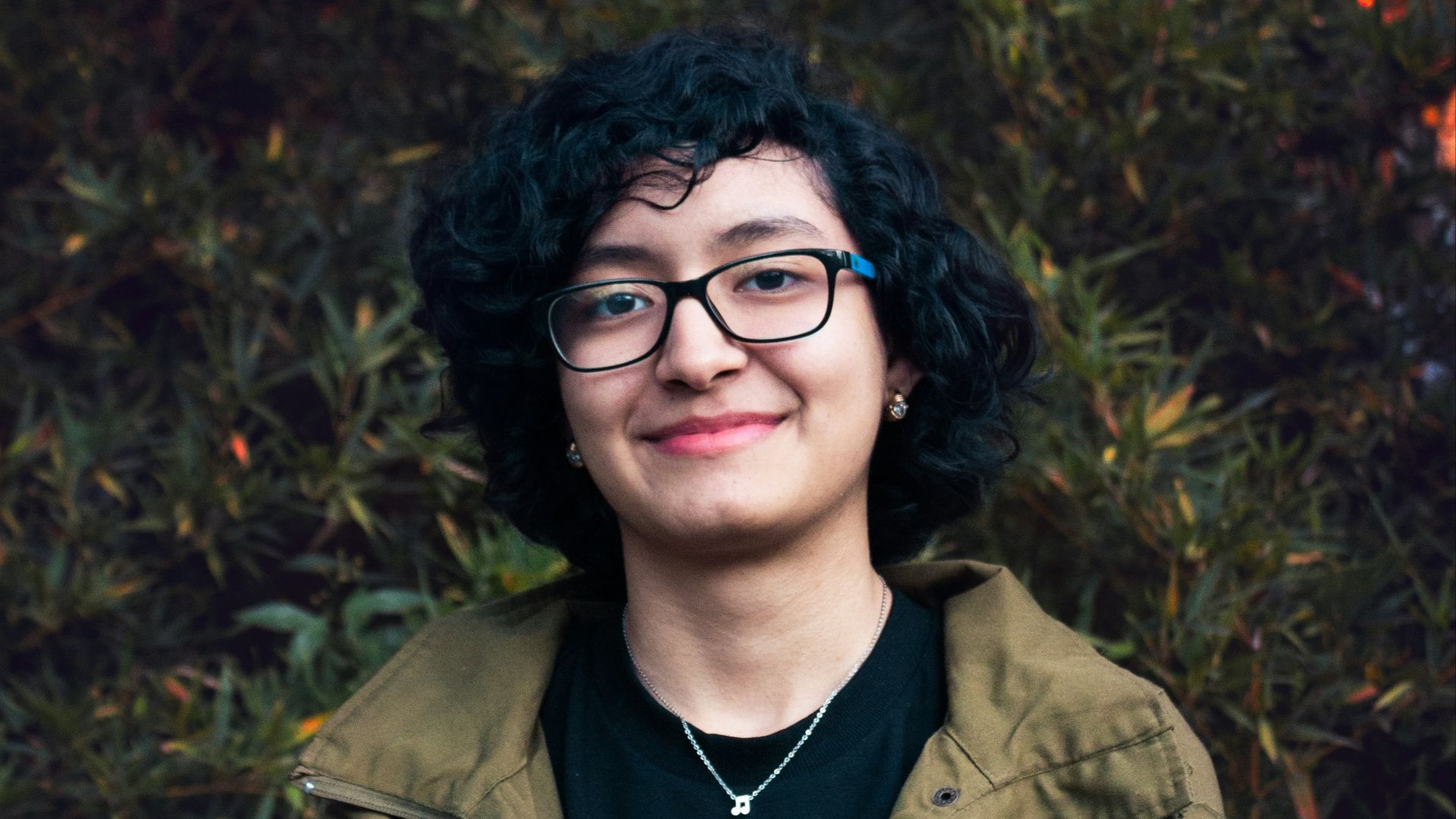 man in brown leather jacket smiling