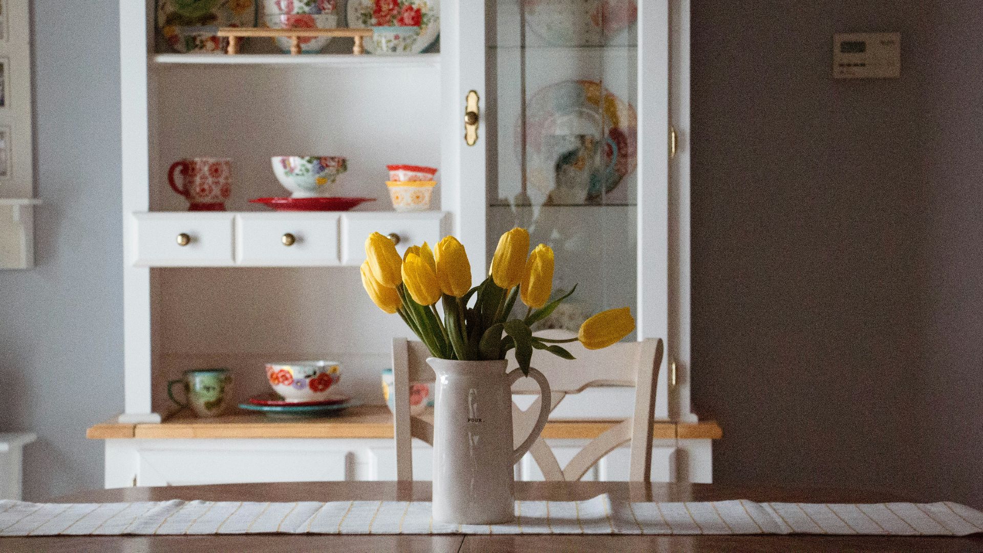 yellow tulip flowers in white ceramic vase