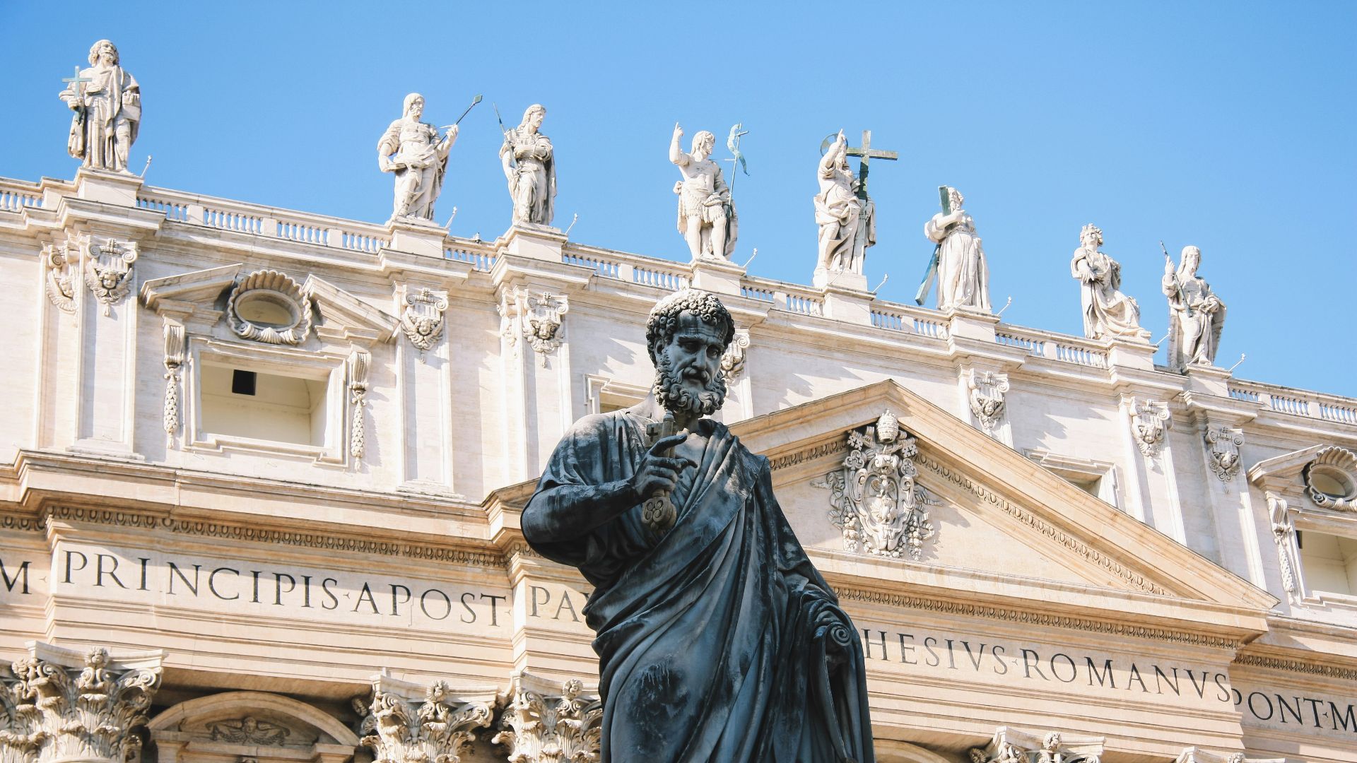 man statue beside concrete building during daytime