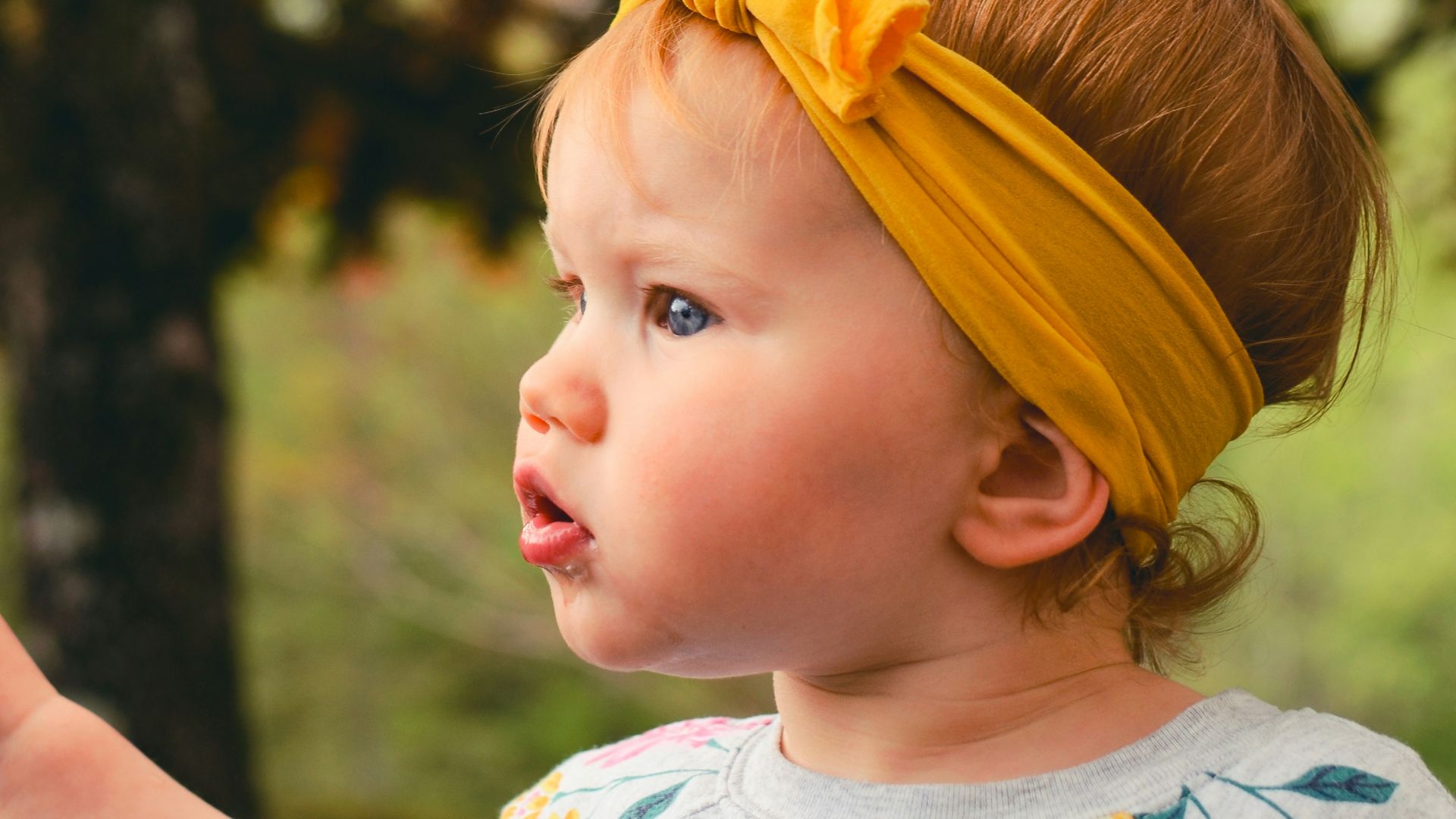 girl wearing gray shirt and yellow headband