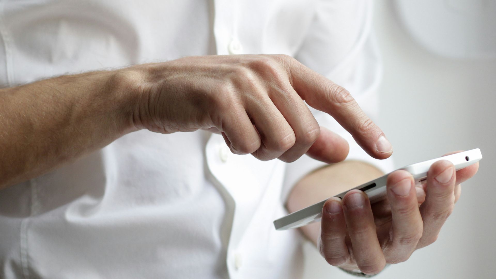 person holding white Android smartphone in white shirt
