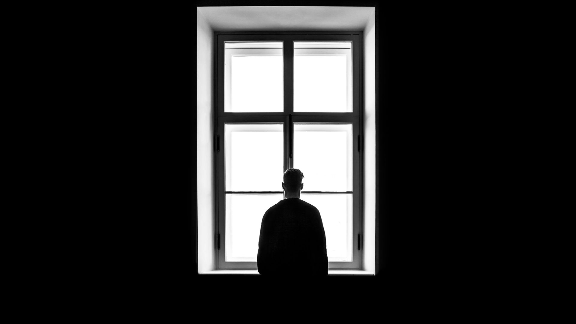man standing in front of the window