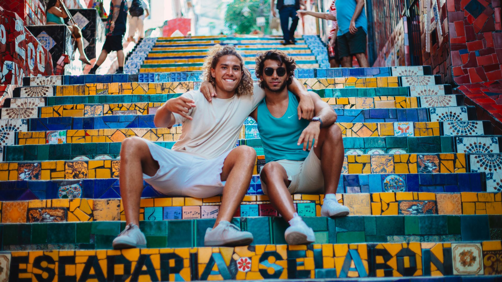 men sitting on concrete stair during daytme