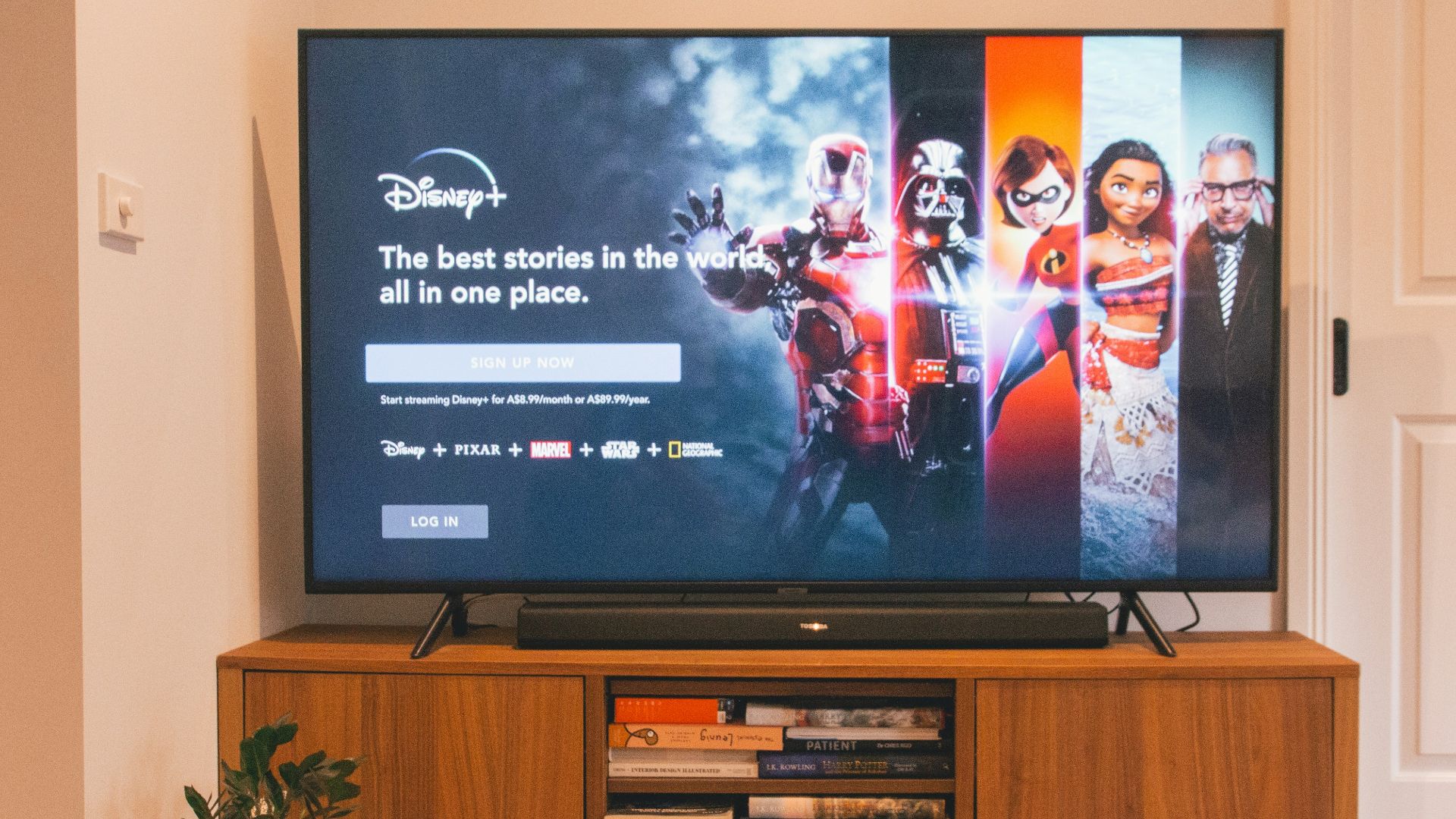 black flat screen tv turned on on brown wooden tv rack