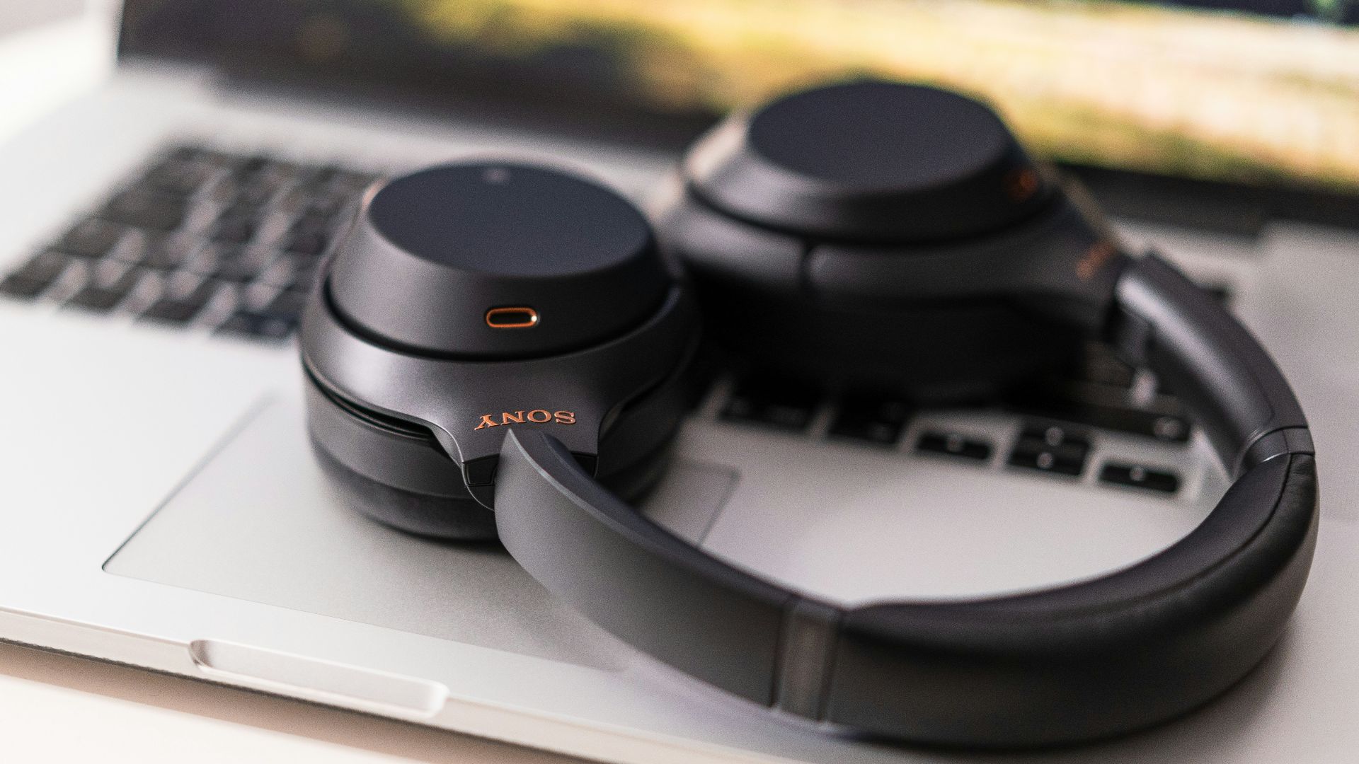 black and gray headphones on macbook pro