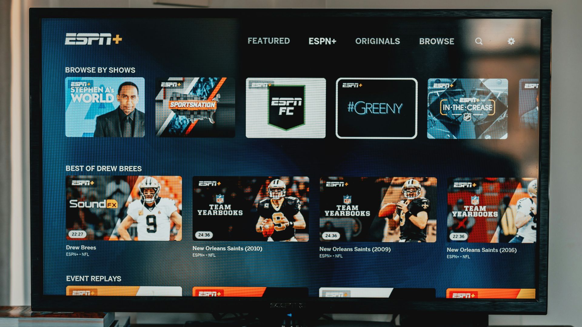 a flat screen tv sitting on top of a wooden table