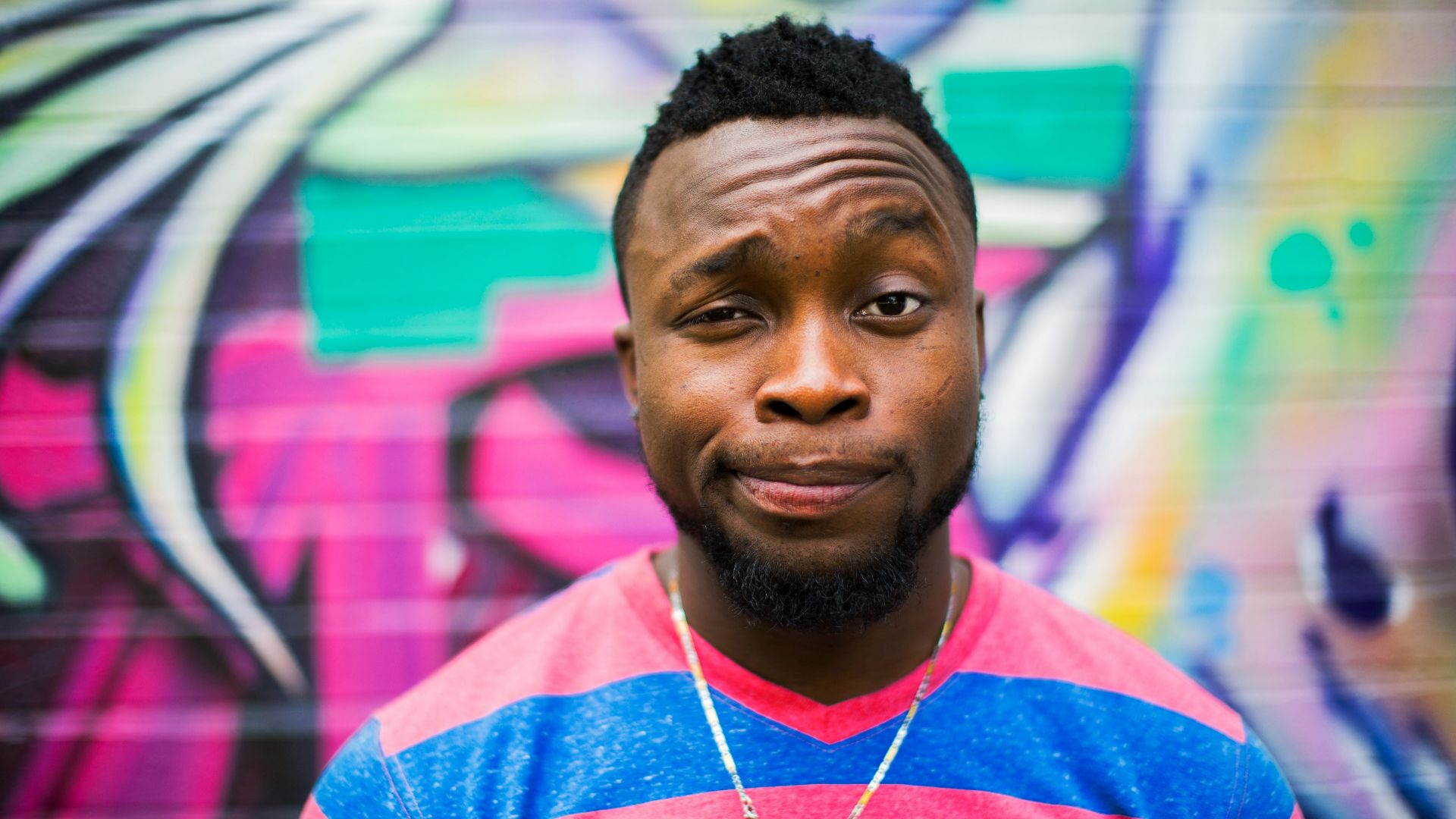 black haired man making face
