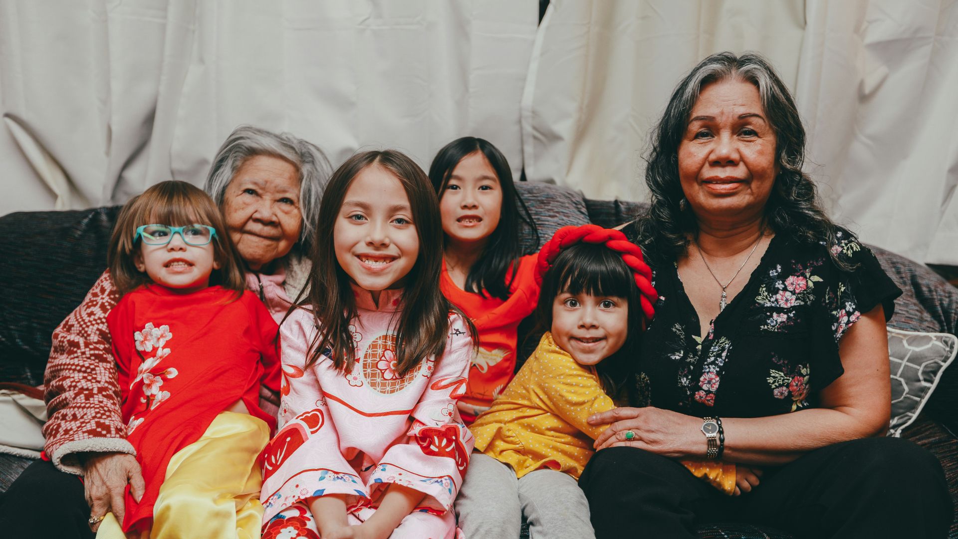 a group of women sitting next to each other on a couch