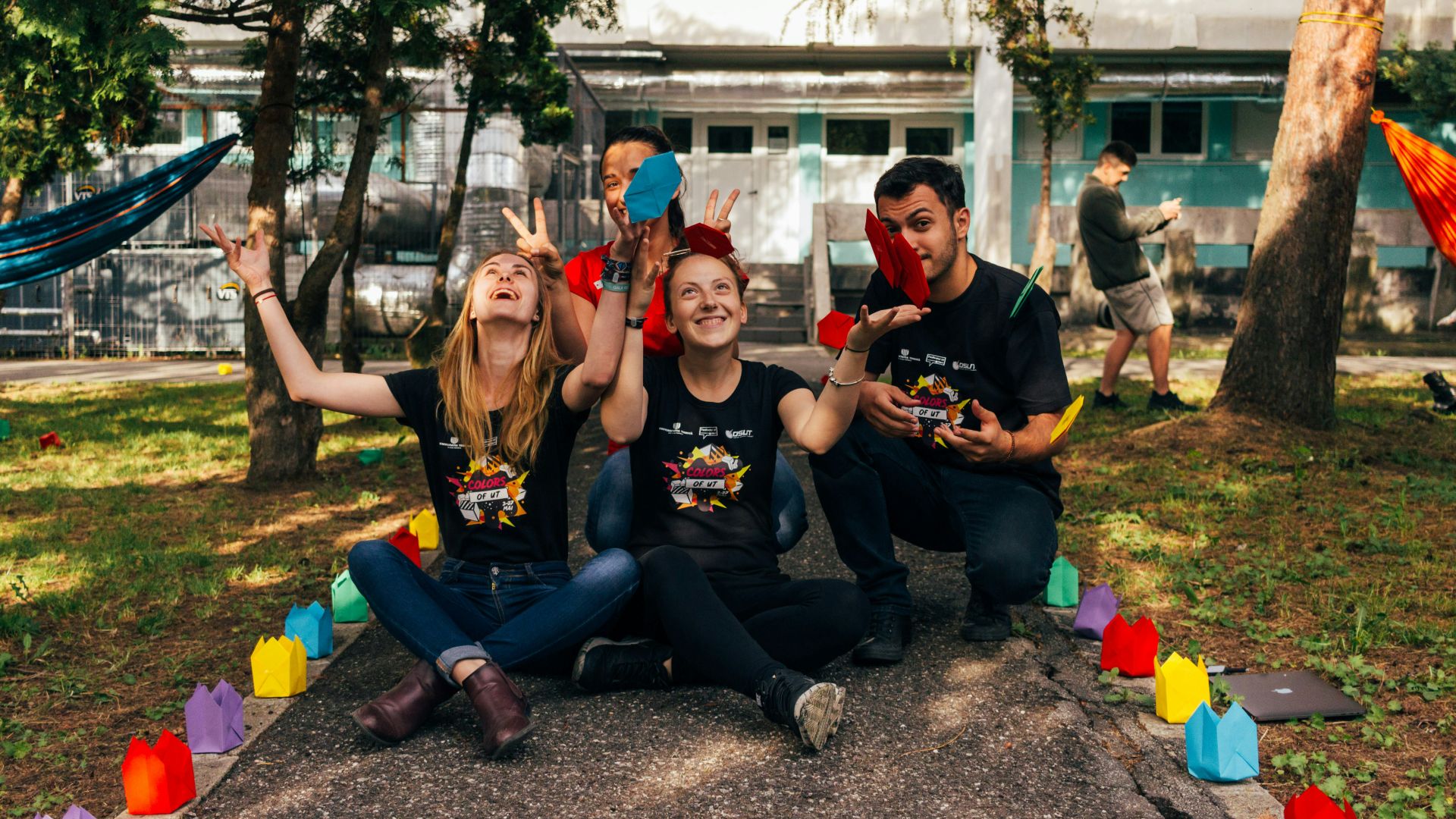 four people sitting near road