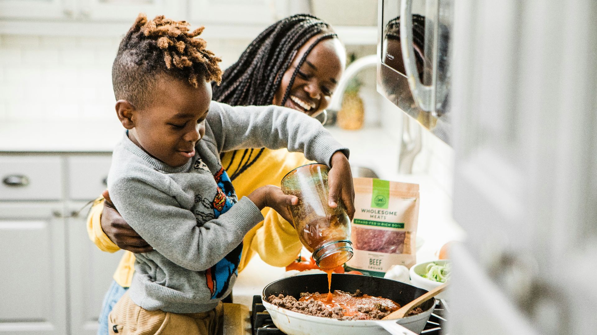 boy in gray long sleeve shirt drinking from bottle