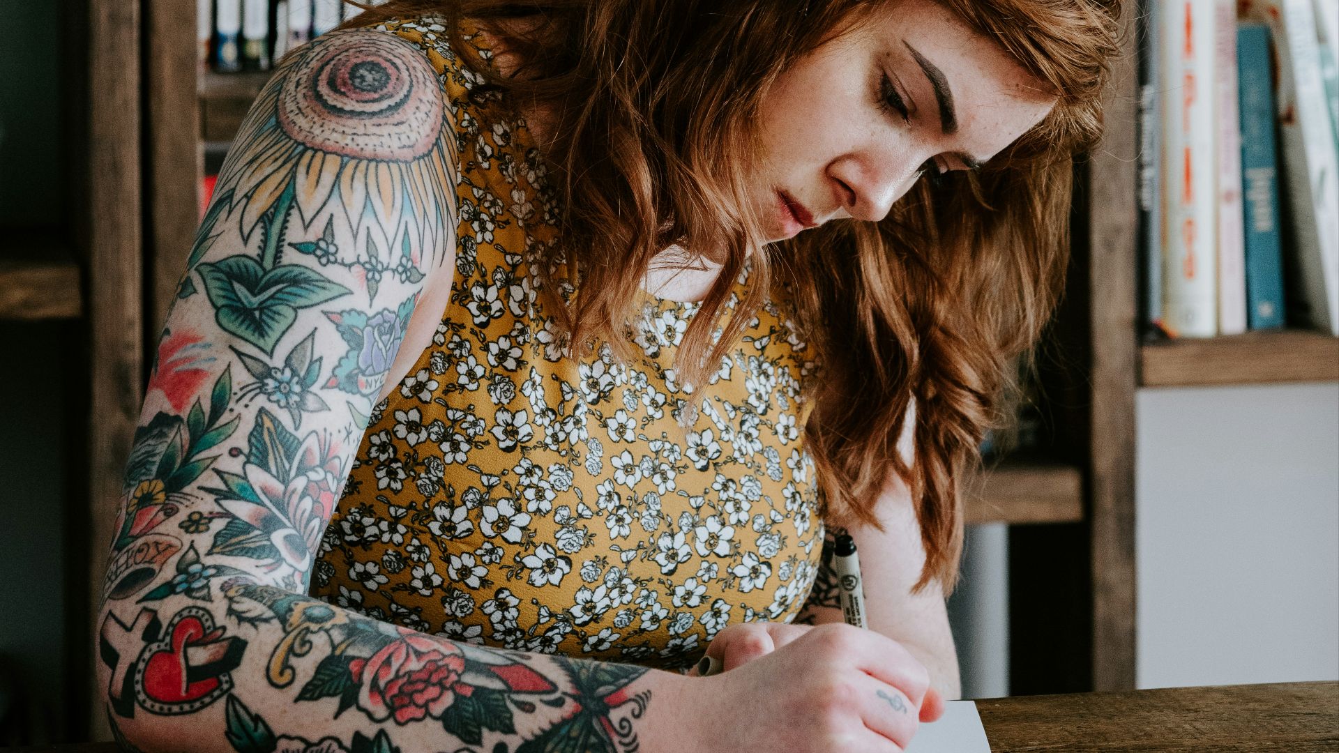woman writing on white paper