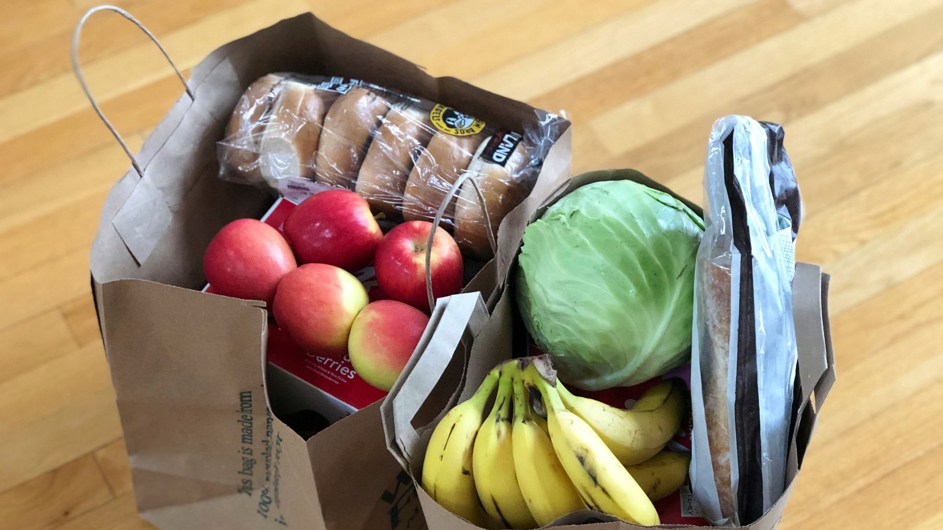 apples and bananas in brown cardboard box