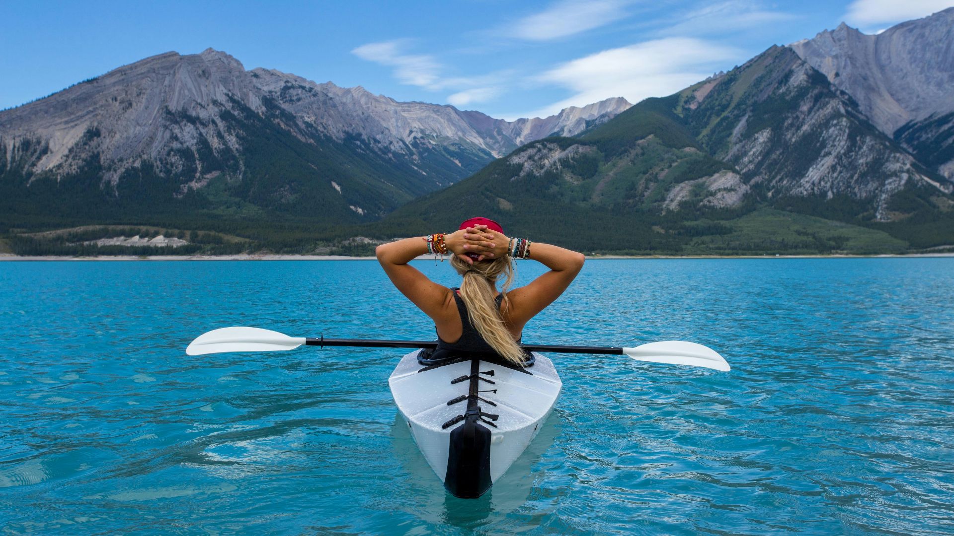 woman riding kayak at the middle of the sea
