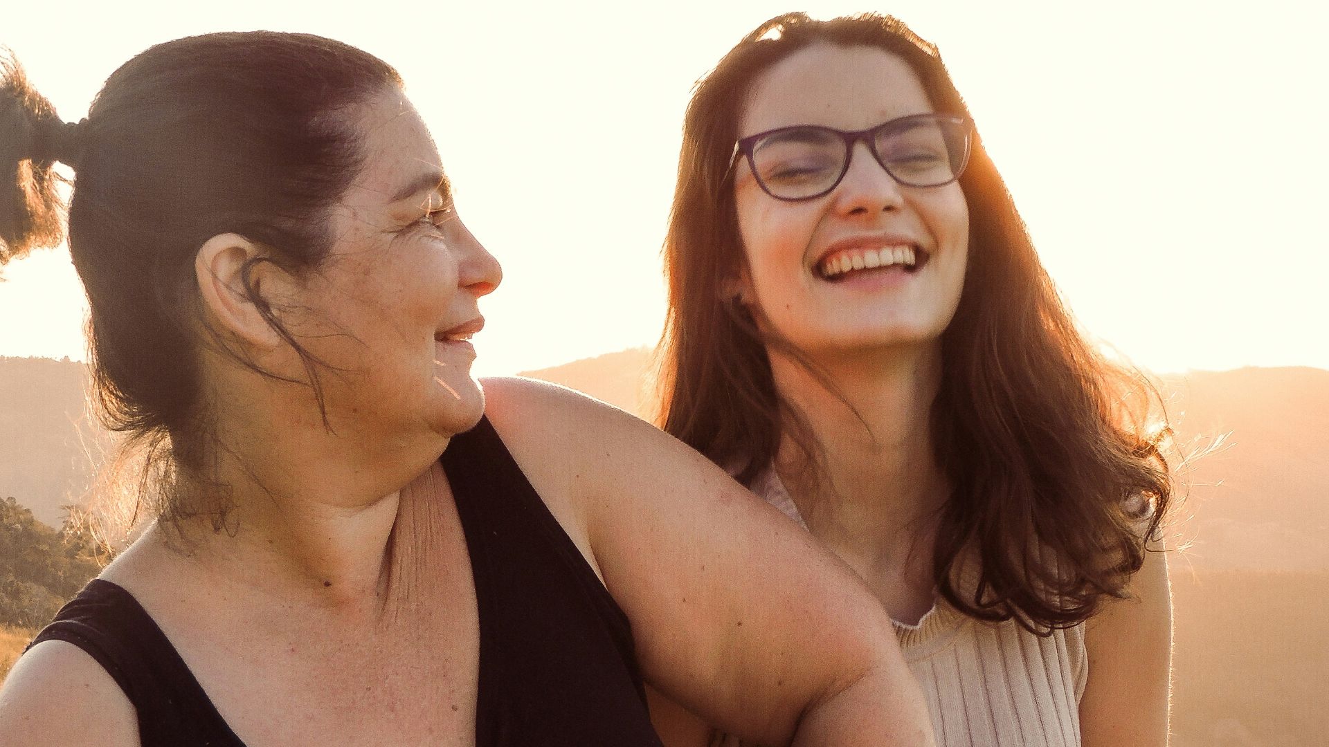 woman in black tank top beside woman in white tank top