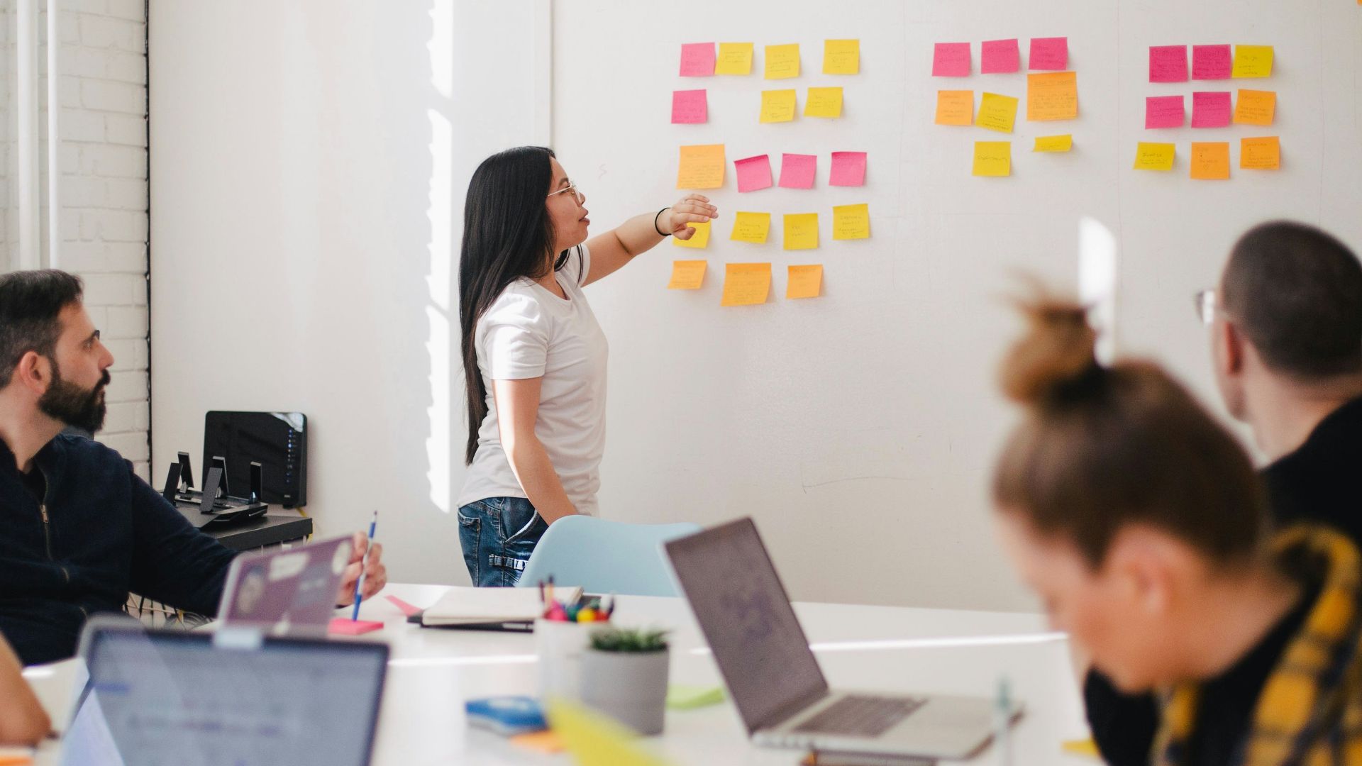 woman placing sticky notes on wall