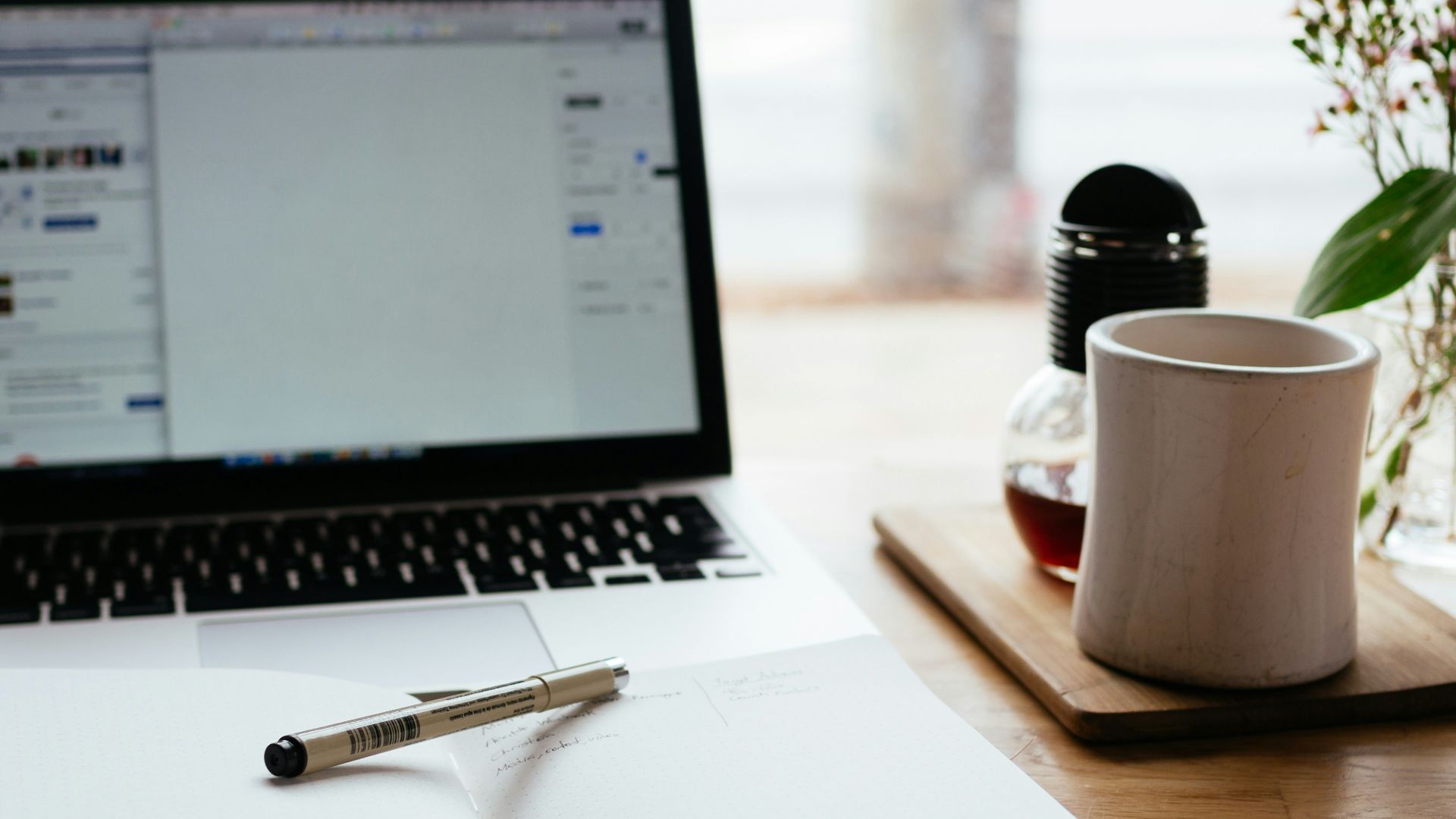 MacBook Pro near white open book