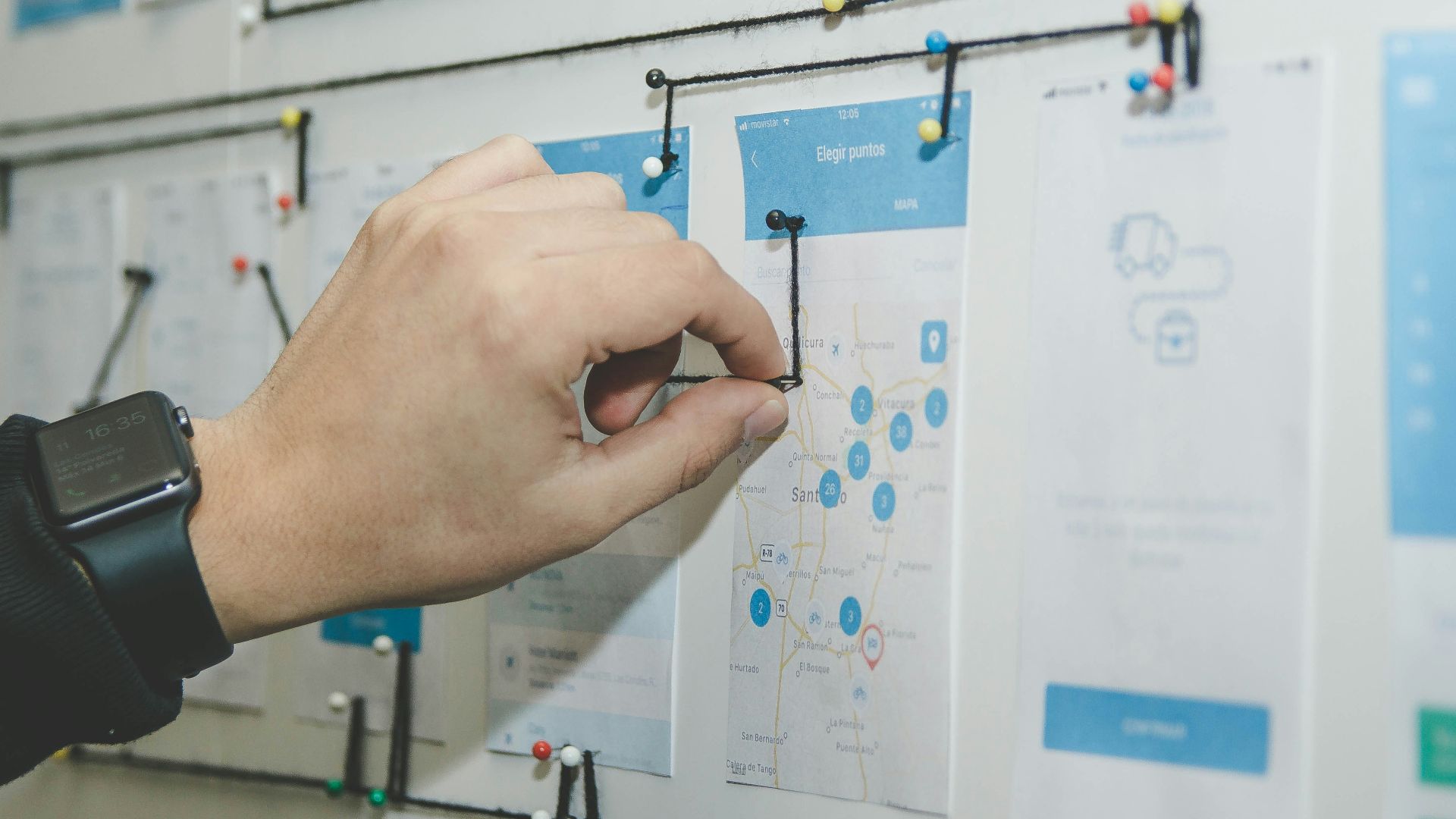 person working on blue and white paper on board