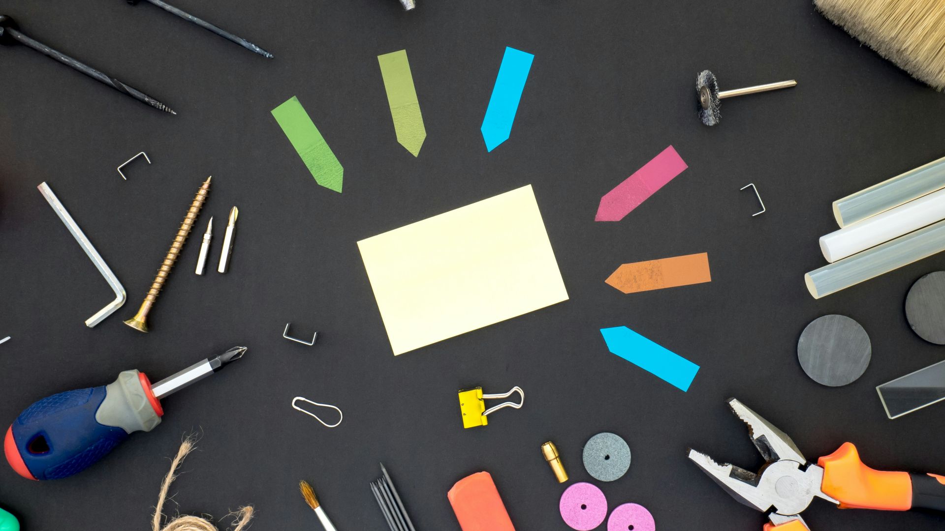 assorted color plastic tools on gray wooden table