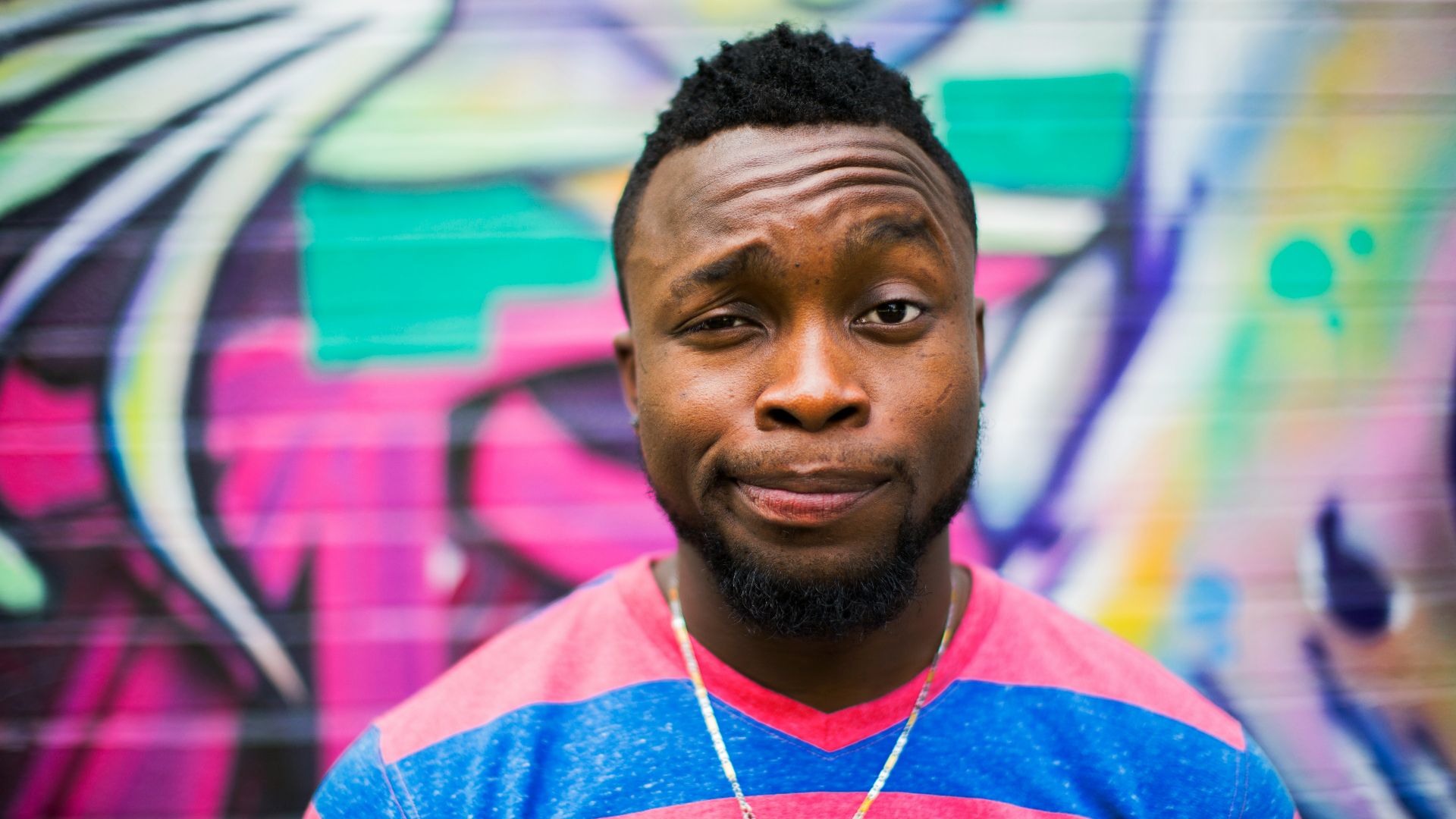 black haired man making face