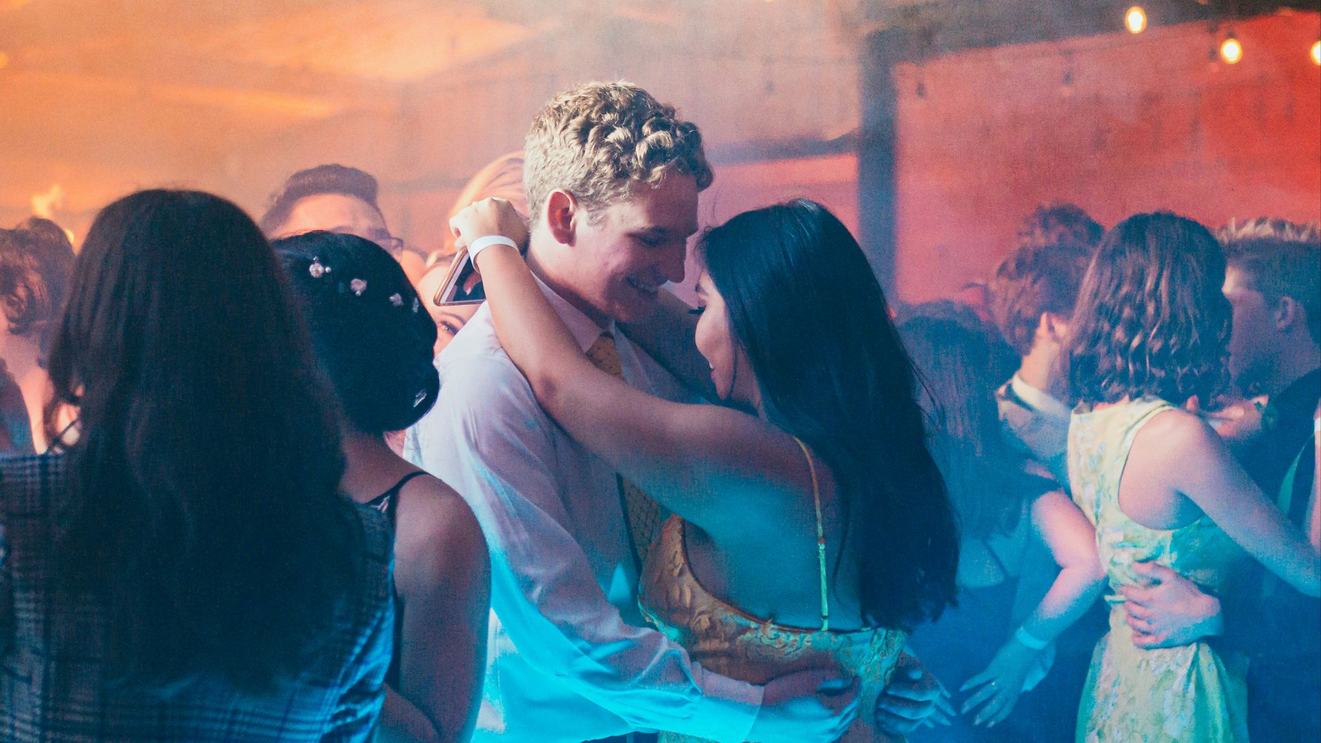 woman in white sleeveless dress kissing man in blue dress shirt
