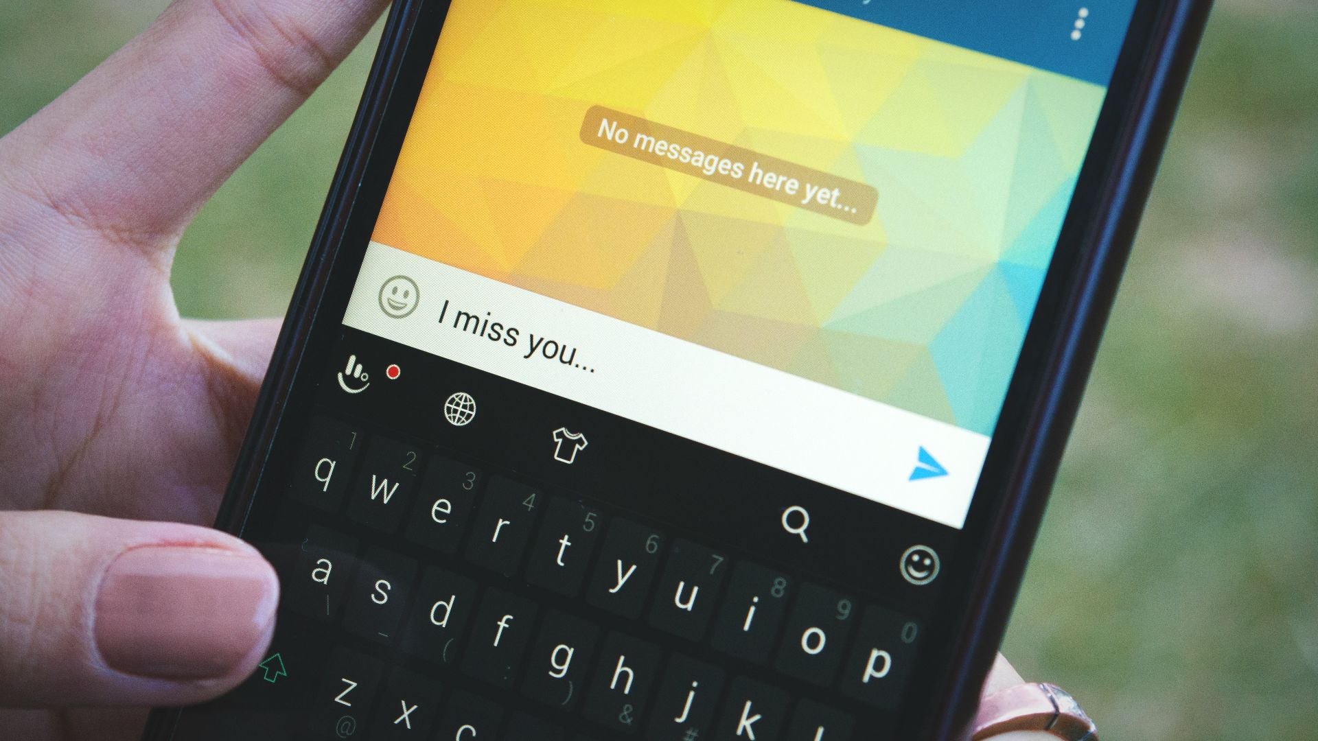 a person holding a cell phone in their hand