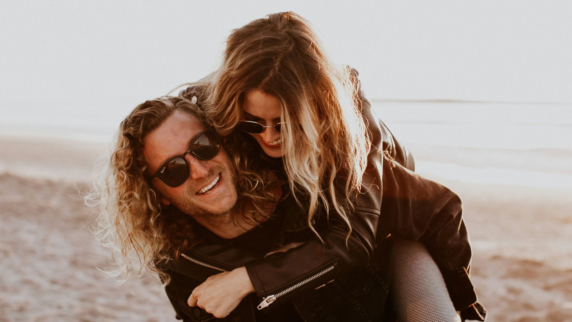 woman in black leather jacket wearing black sunglasses