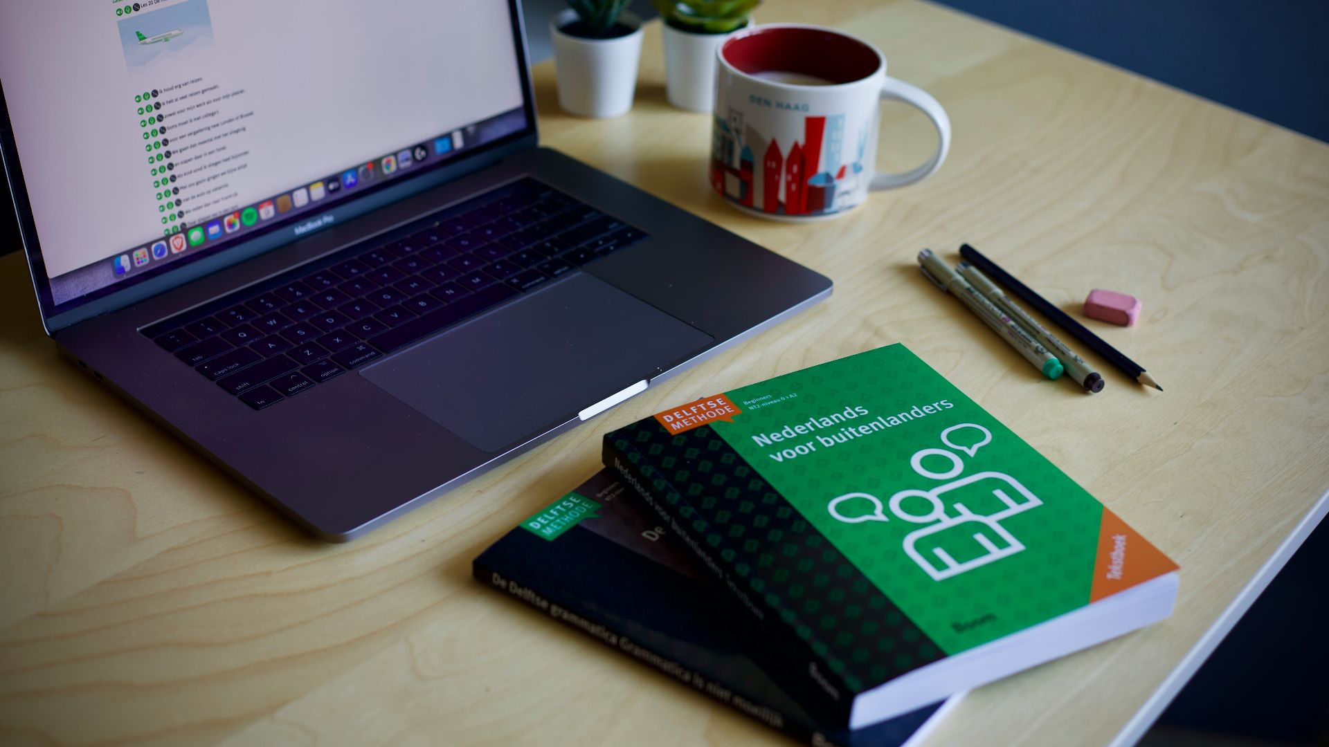 black and silver laptop computer beside white and red ceramic mug