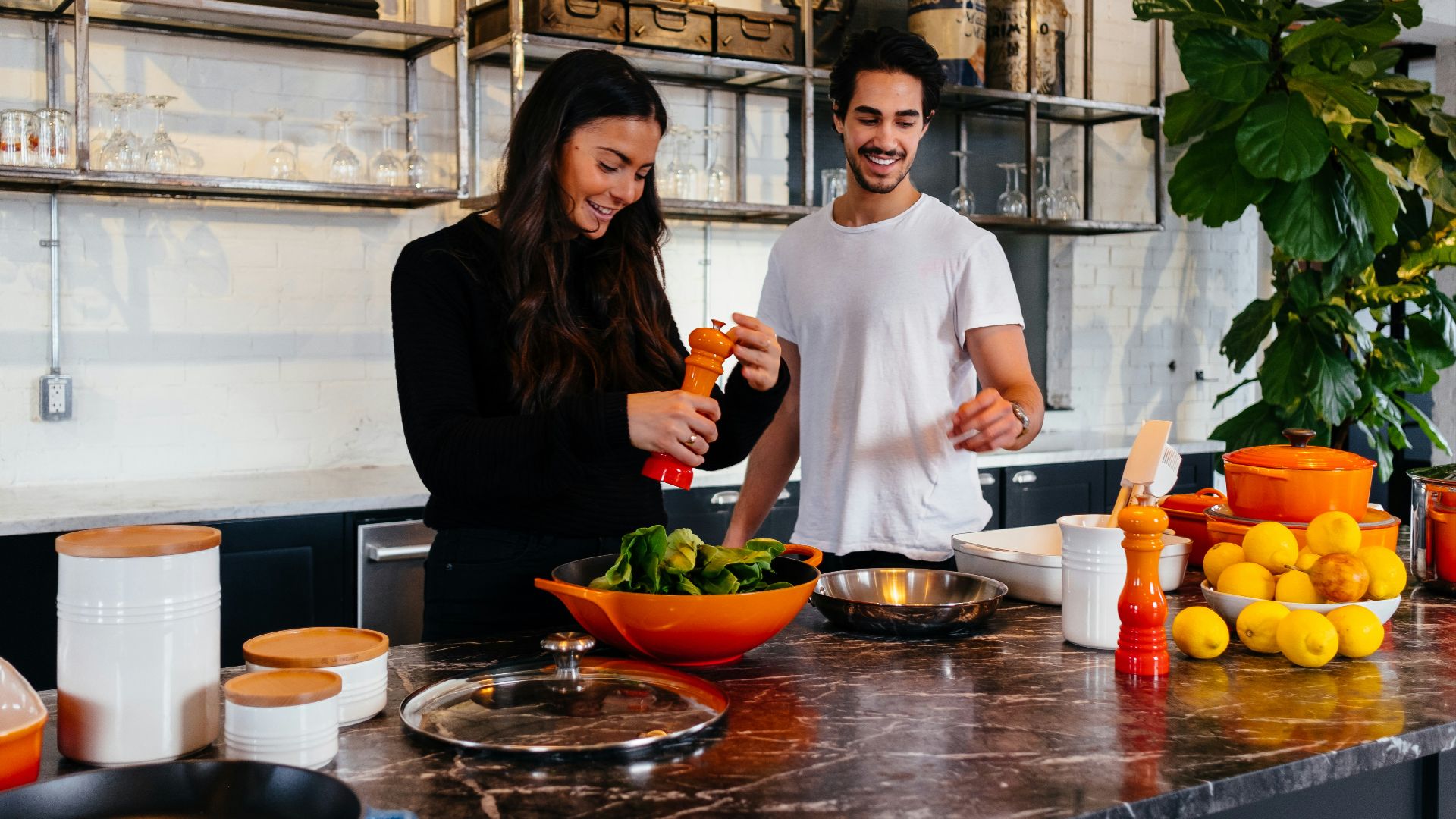 man and woman standing in front of table