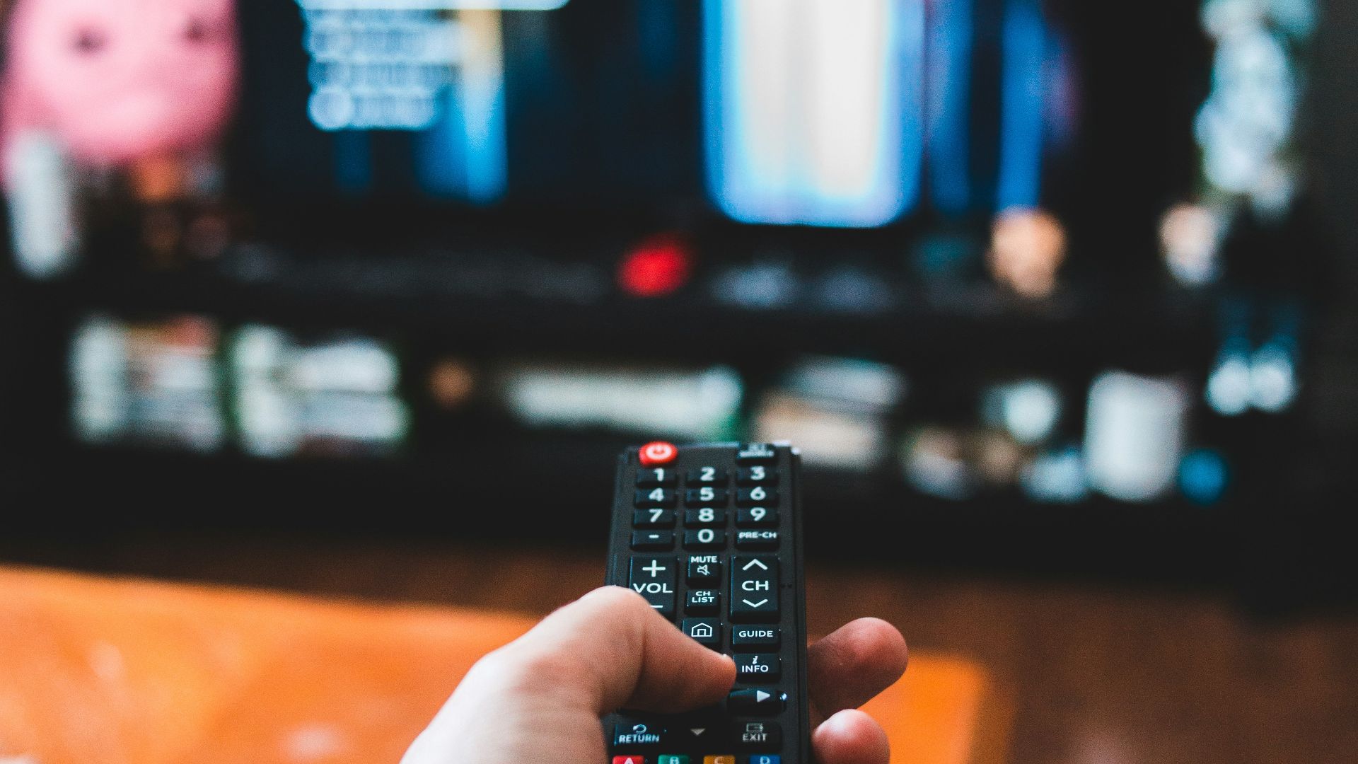 person holding black remote control