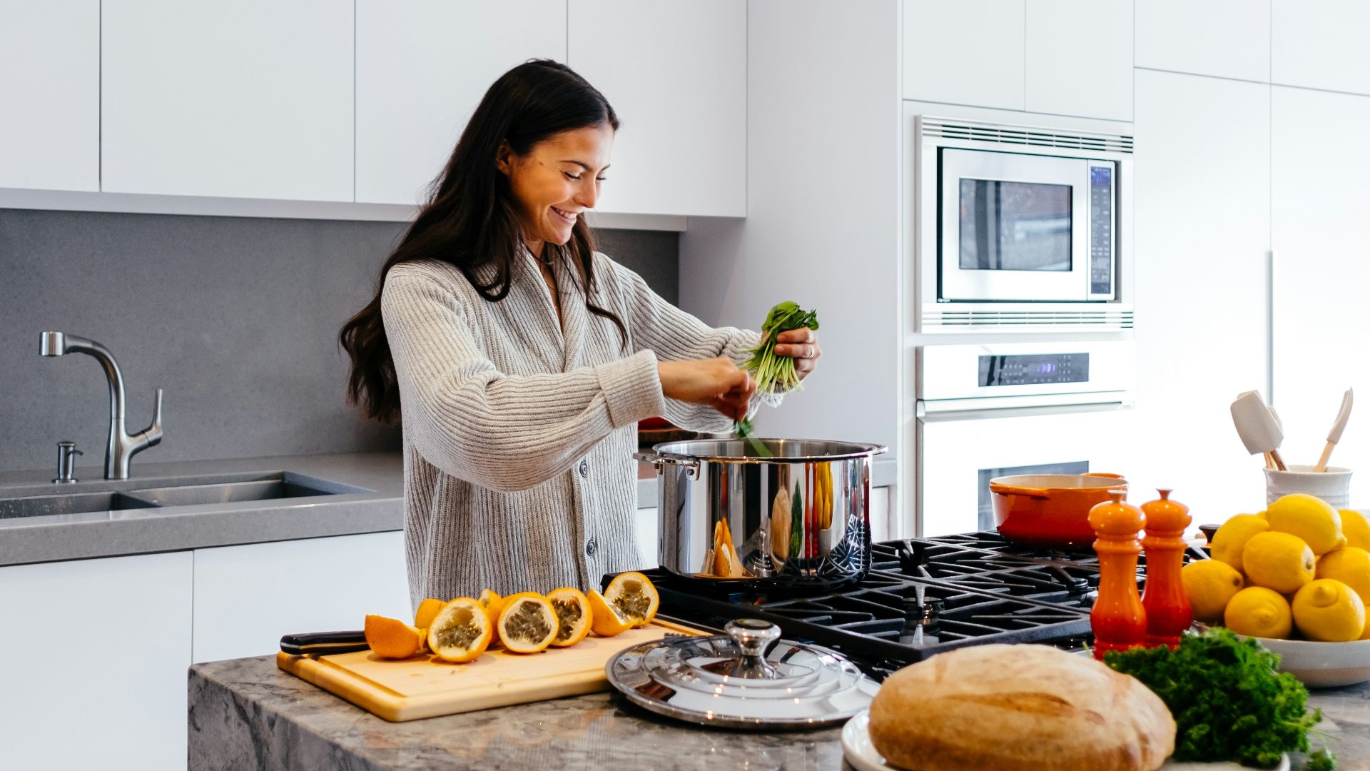 woman smiling while cooking