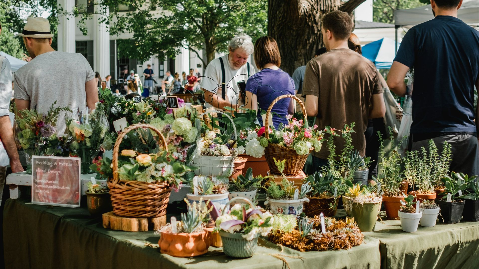 people beside assorted plants on table