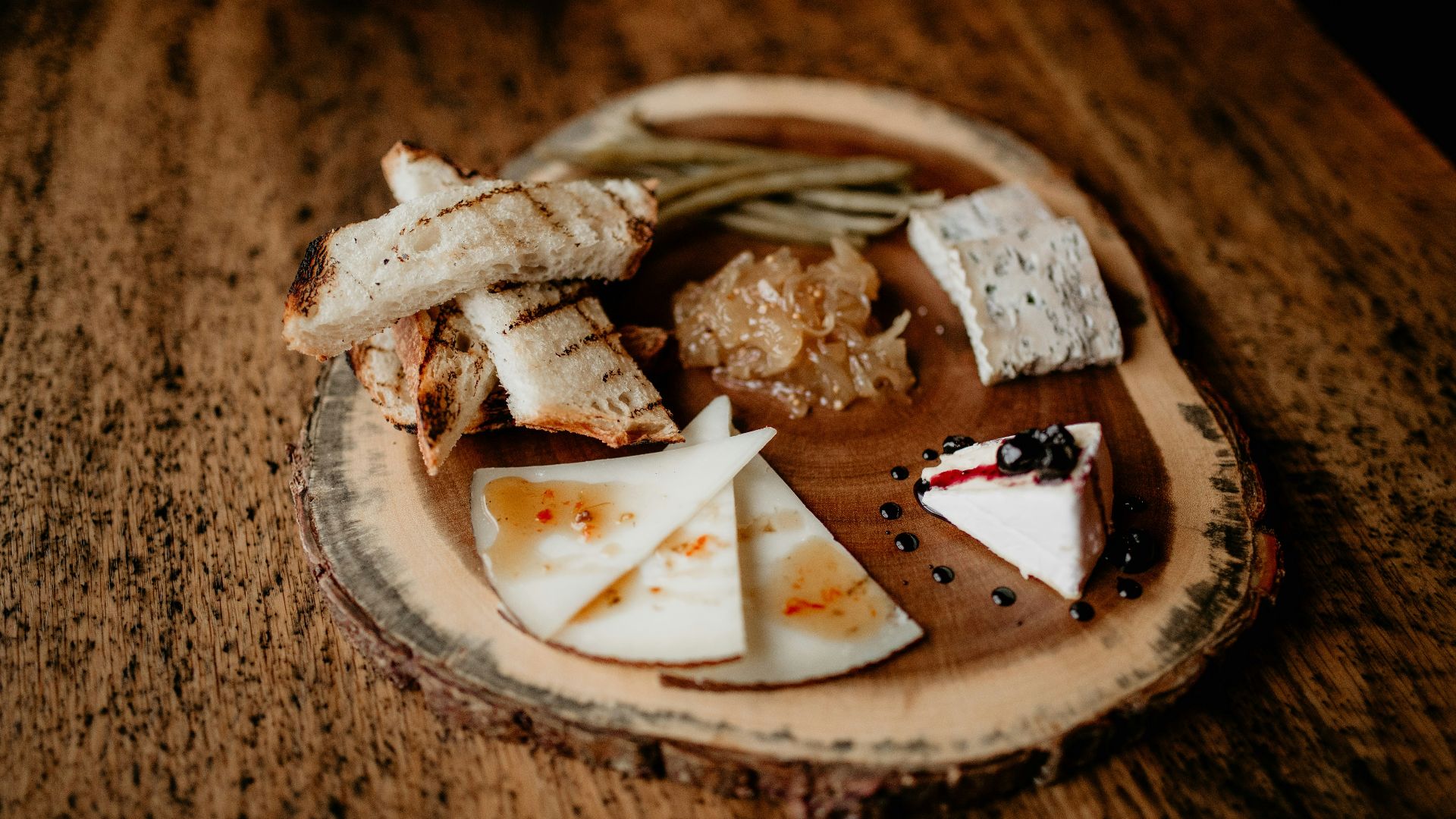 a plate of cheese and crackers on a wooden table