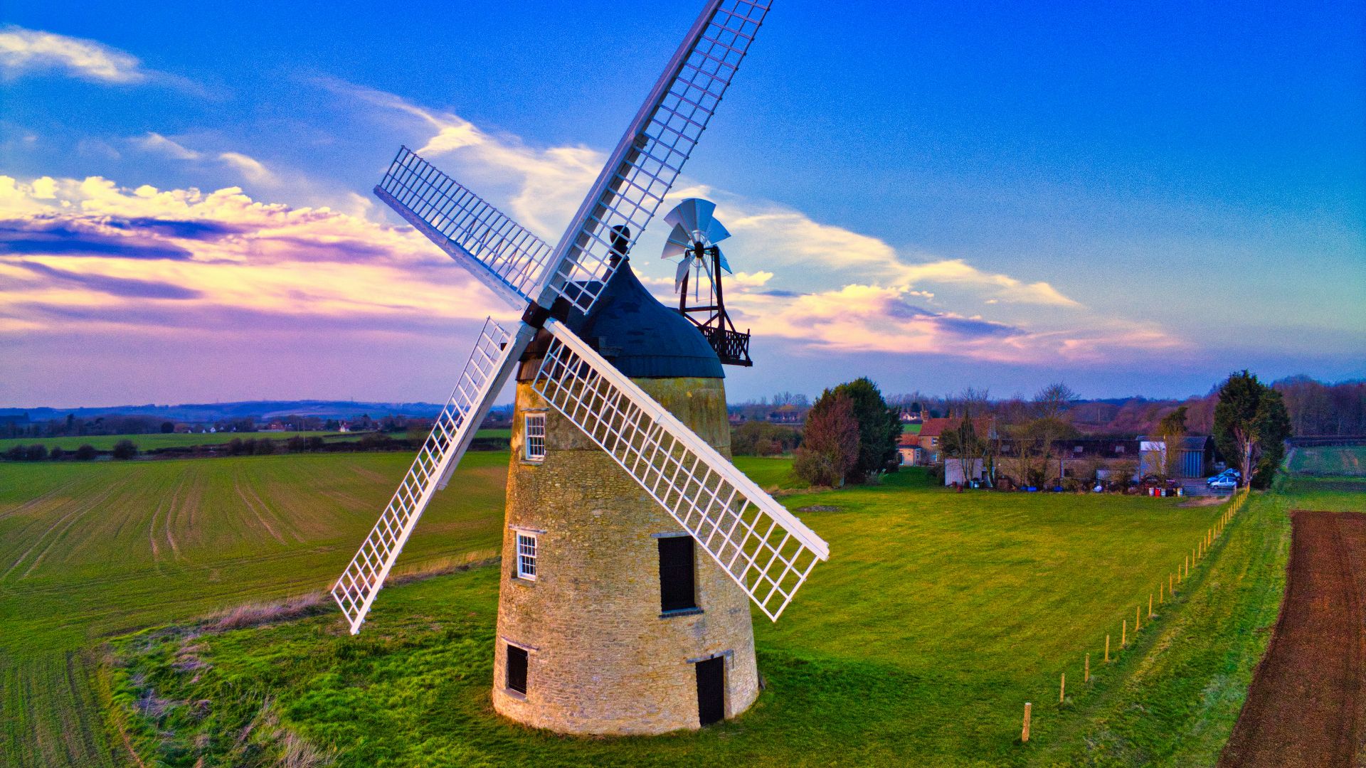 wine mill at the field under blue and grey cloudy sky