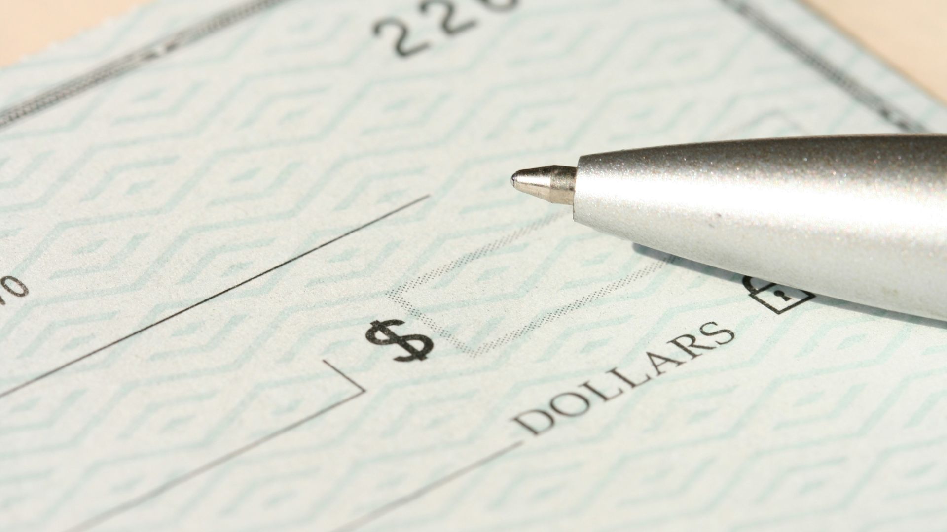 a pen sitting on top of a cheque paper