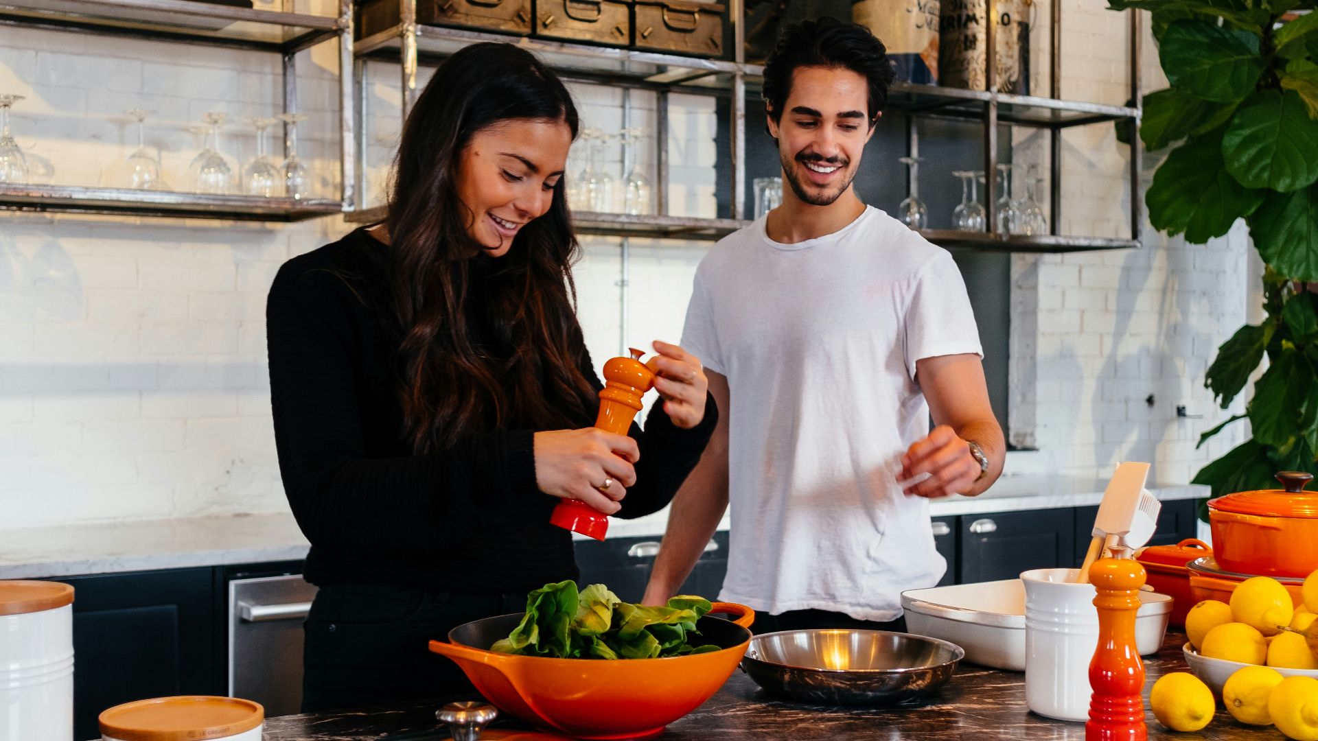 man and woman standing in front of table