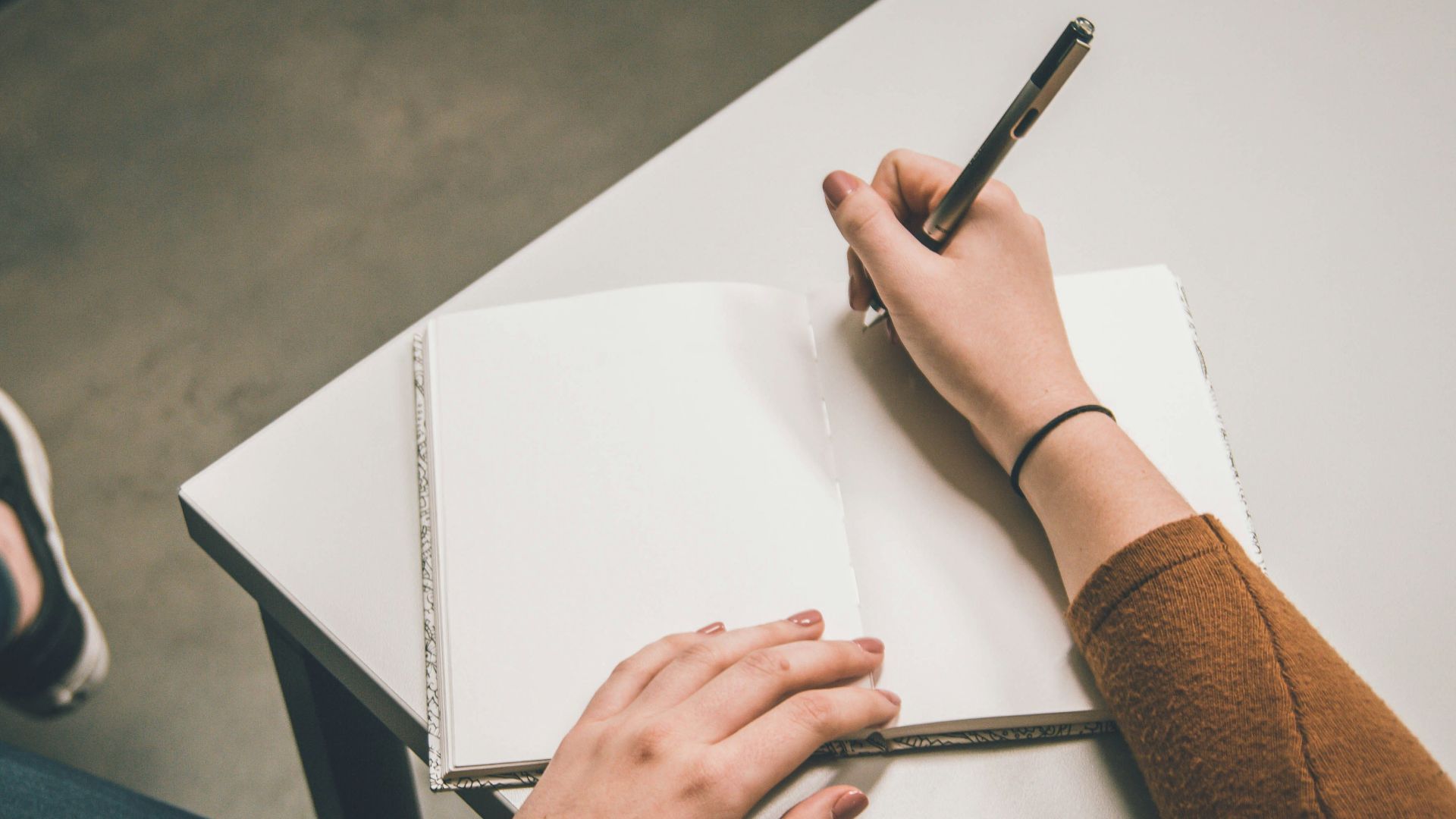 person writing on white paper