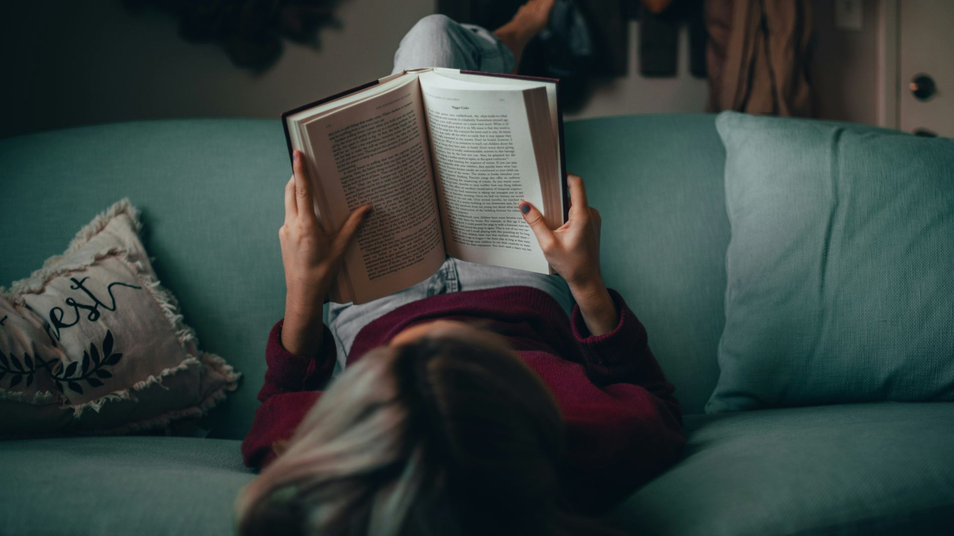 woman in red shirt reading book