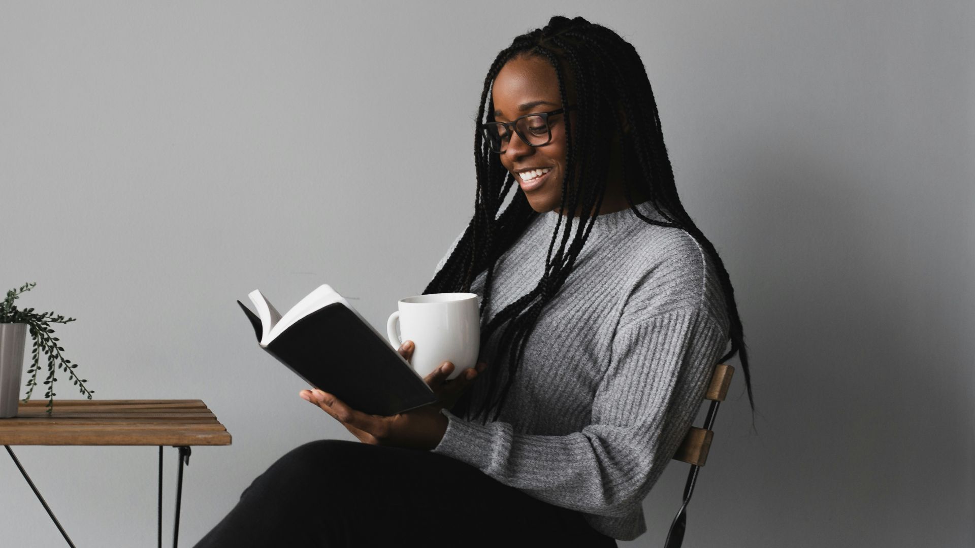 woman in white and black stripe long sleeve shirt sitting on chair