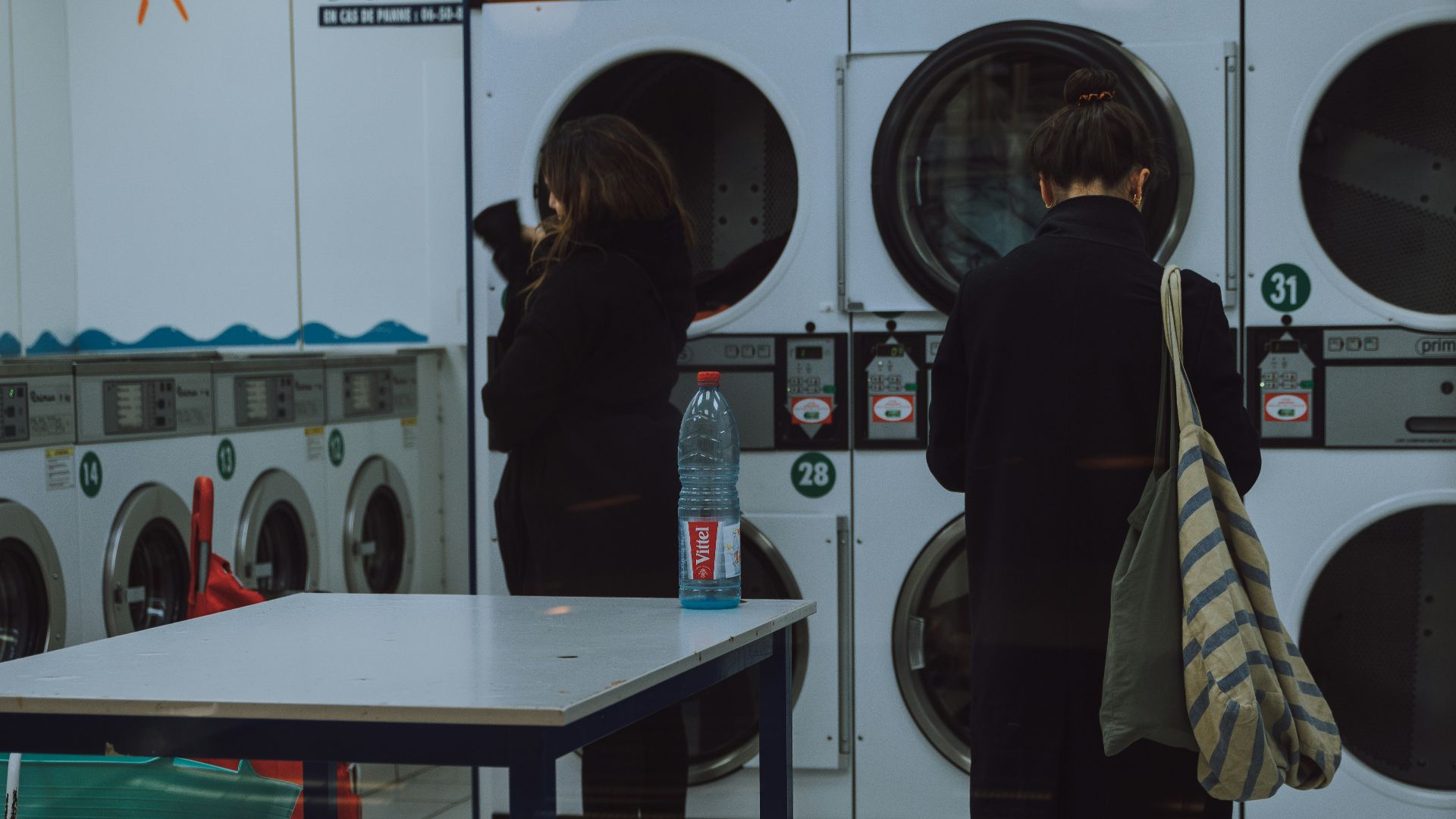 woman standing in front of the front load washer