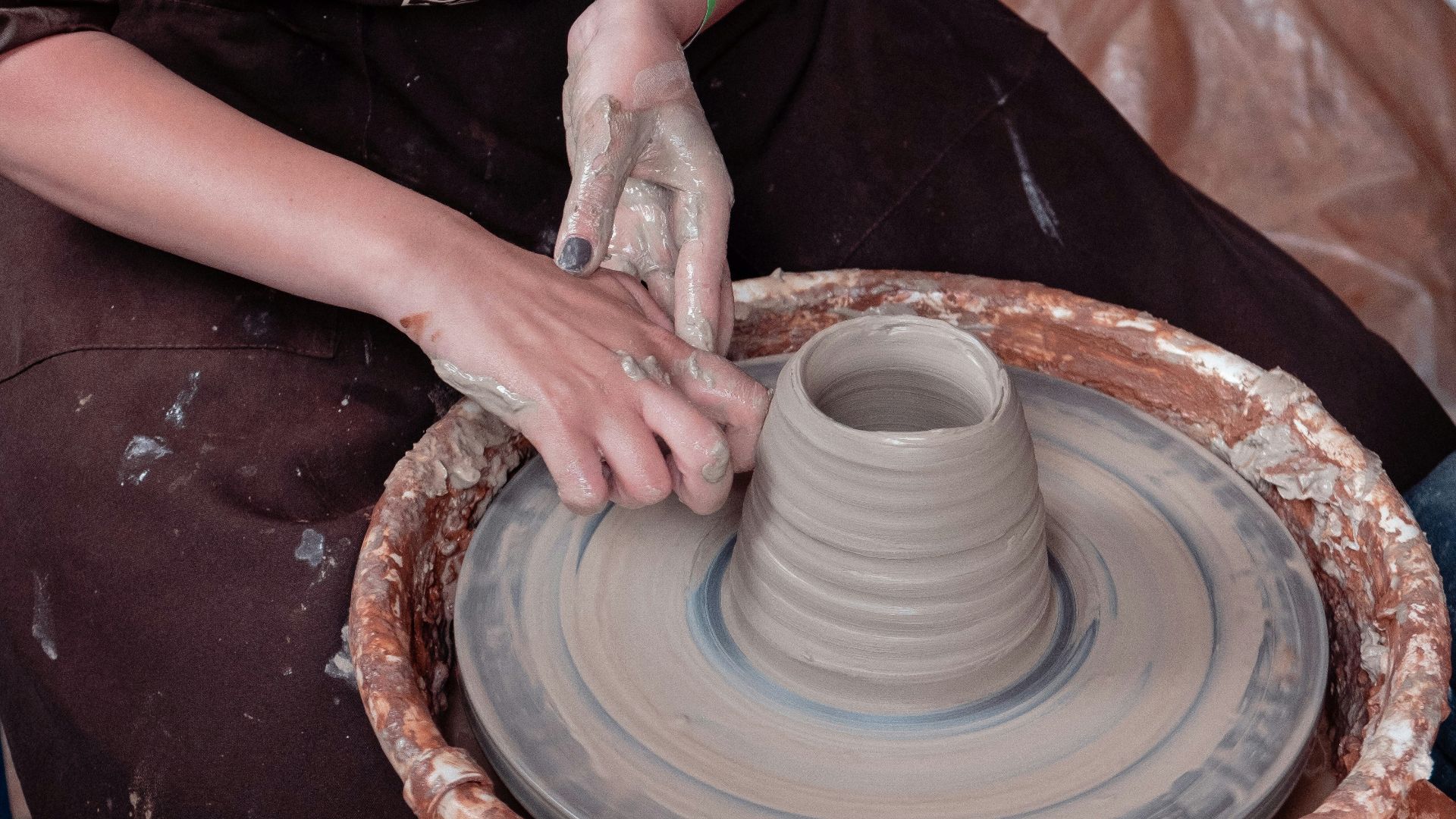 woman in black and white shirt holding white ceramic round plate