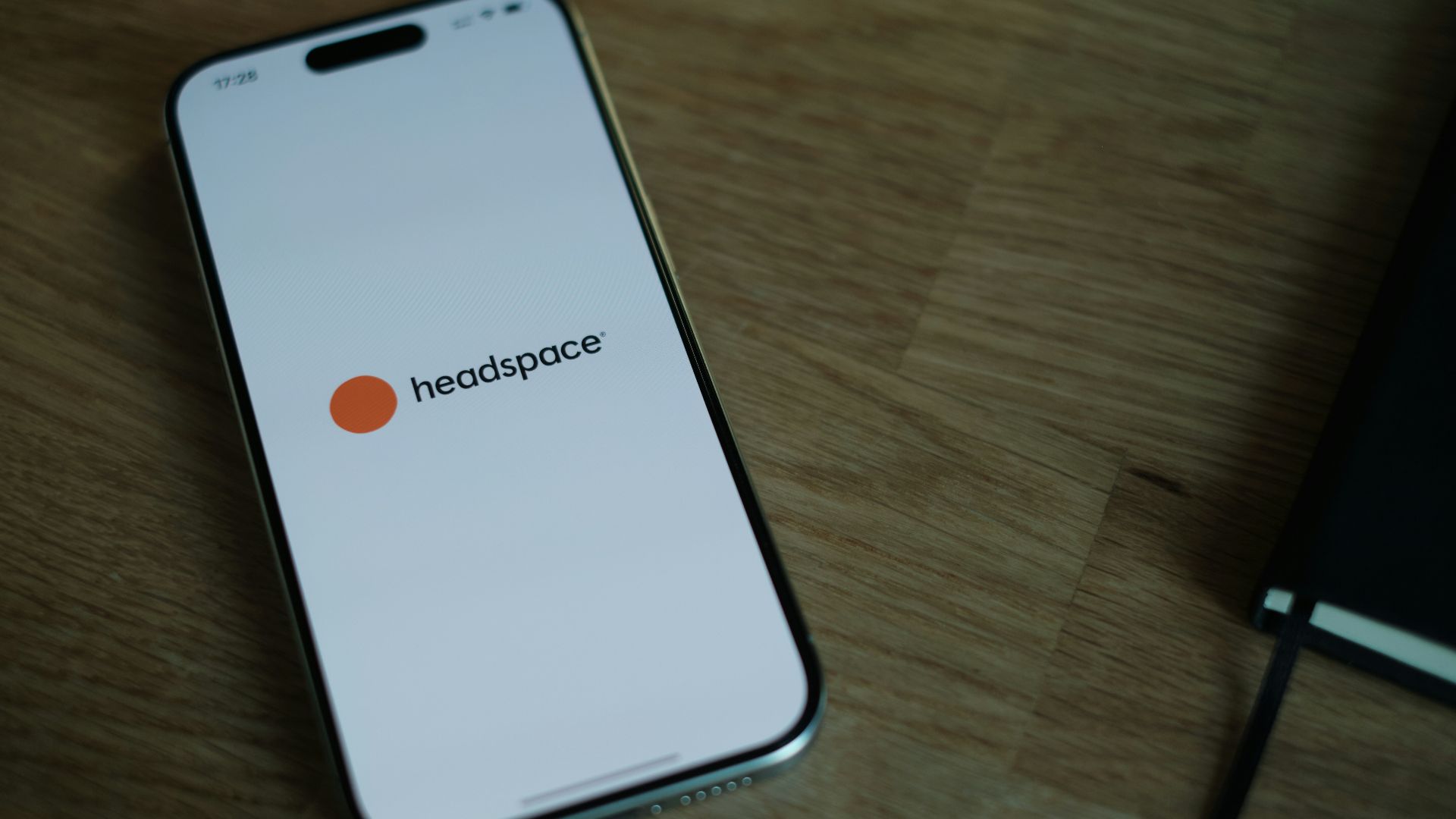 A cell phone sitting on top of a wooden table