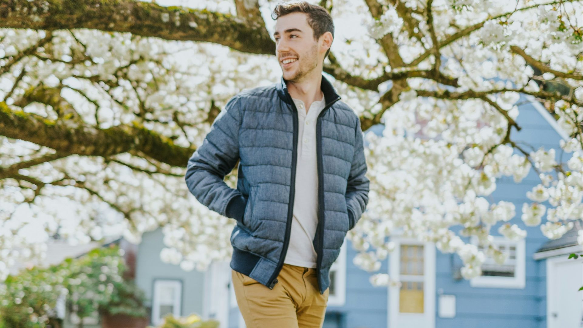 man in blue jacket standing on pathway during daytime