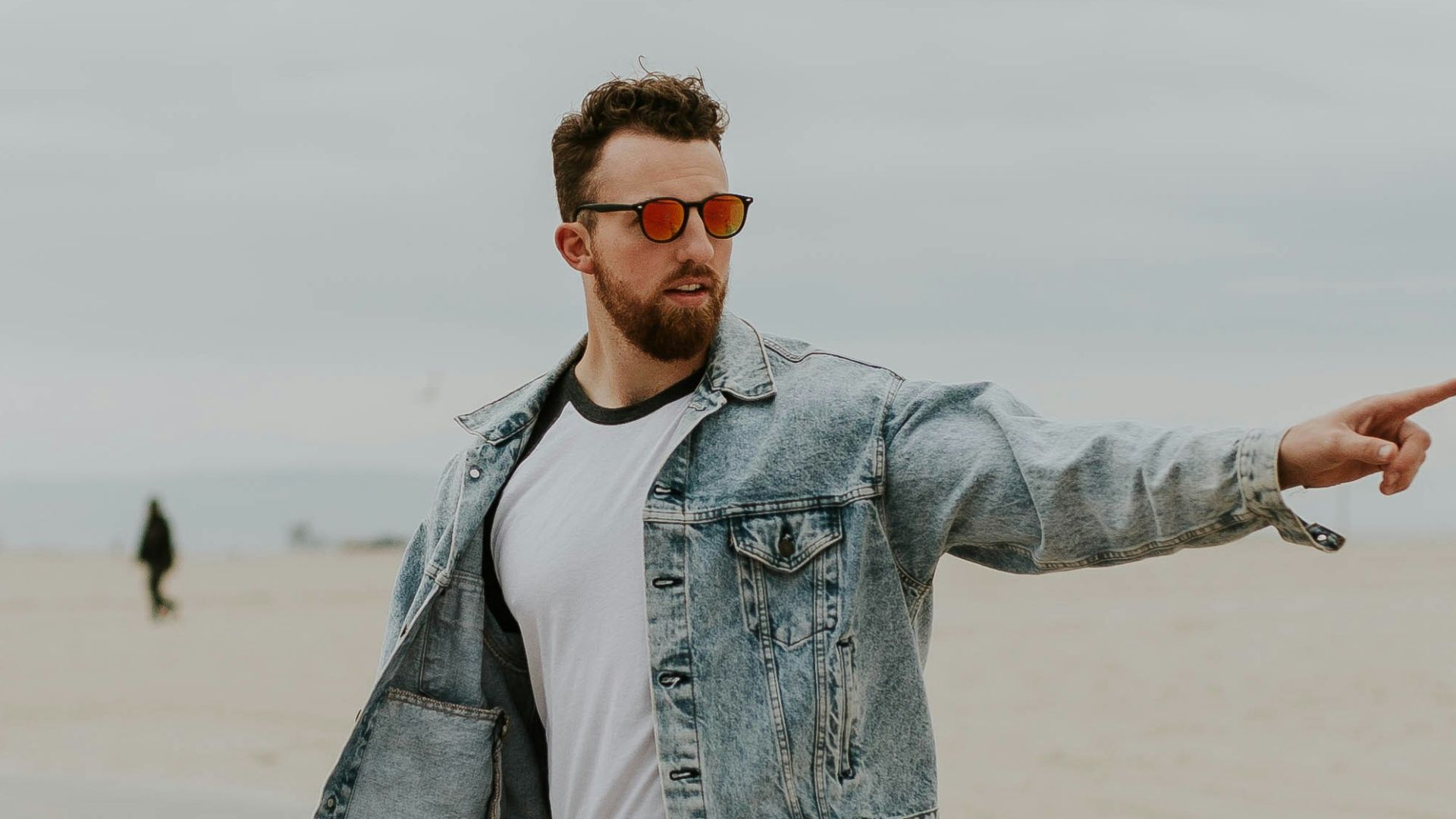 men's washed denim jacket riding a skateboard