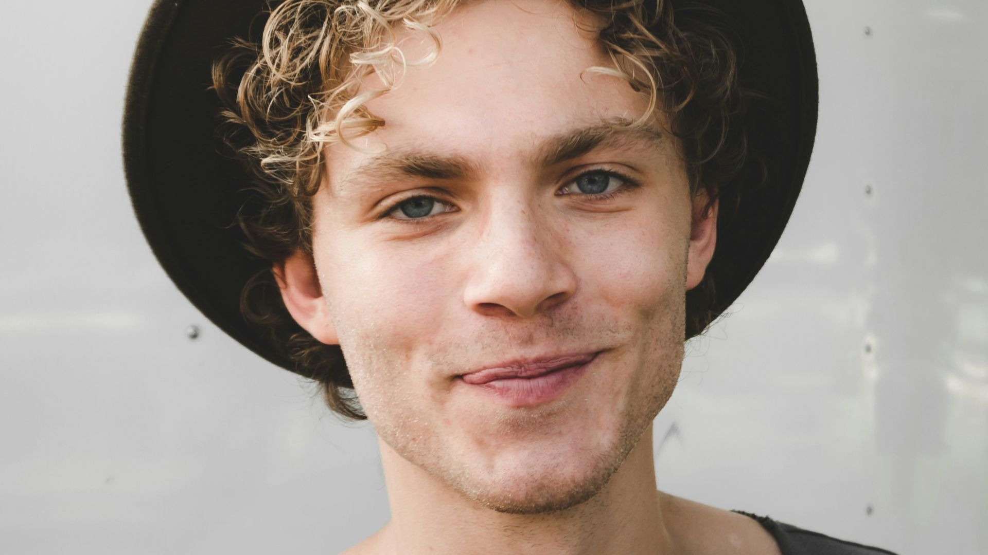 man standing near white wall