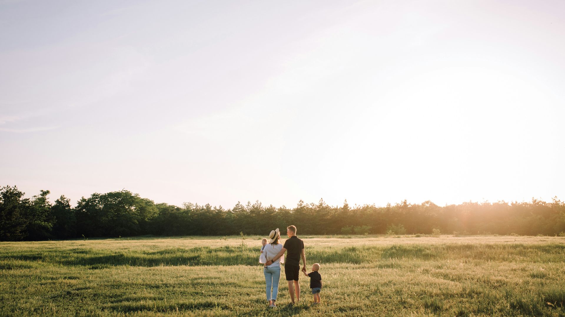 man and woman walking on green grass field during daytime