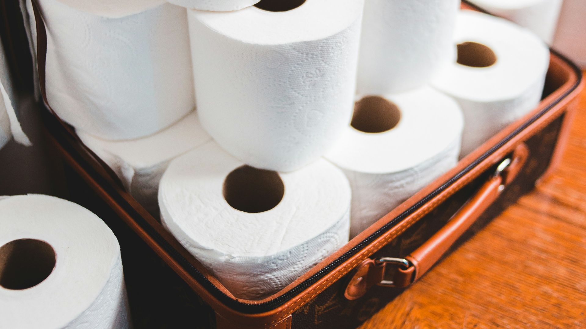 white toilet paper roll on brown wooden table
